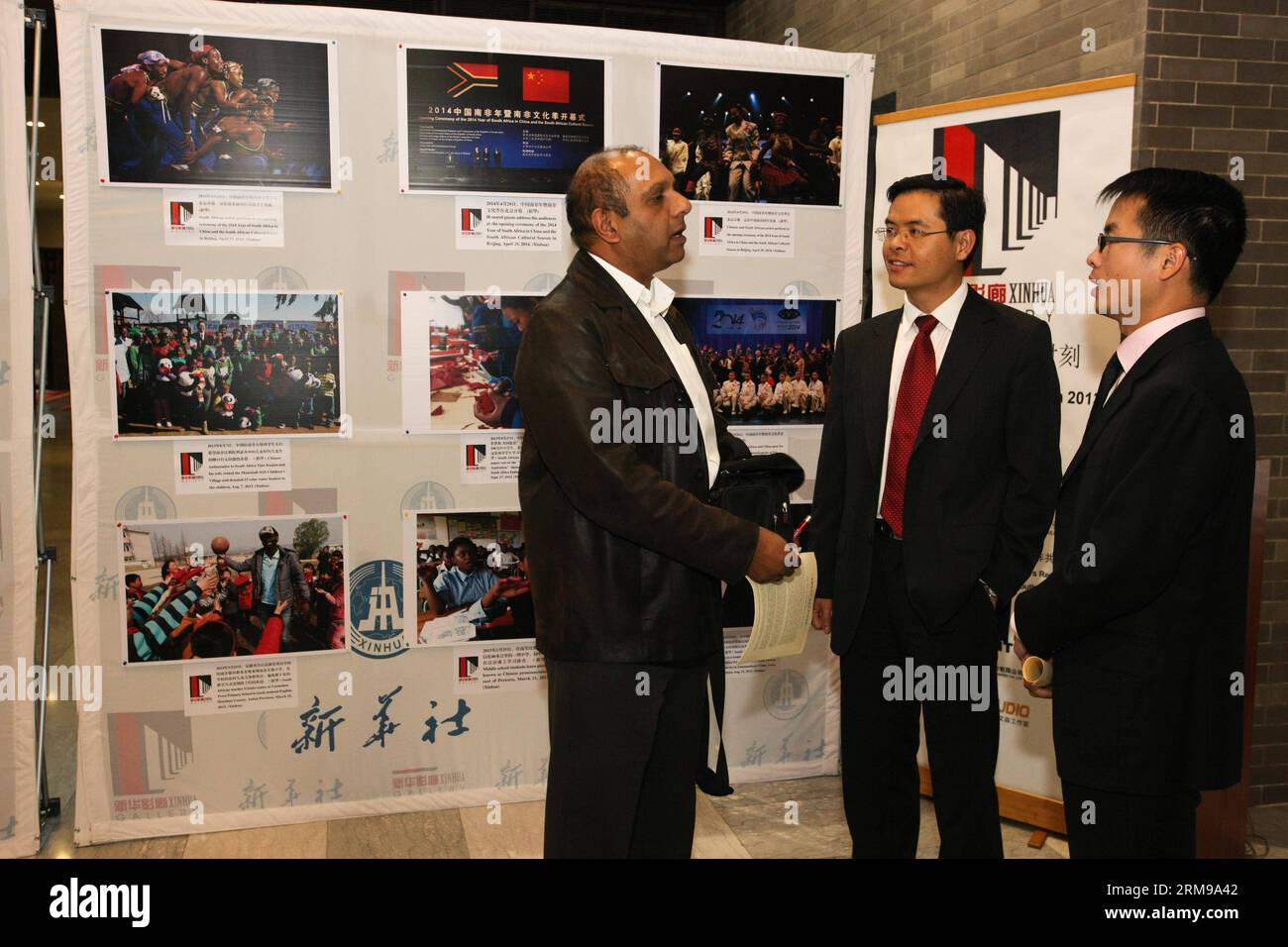 (140514) -- PRETORIA, May 14, 2014 (Xinhua) -- A South African journalist (L) talks with exhibition organizers during the Xinhua Gallery Exhibition held at the Chinese Embassy in South Africa in Pretoria, South Africa, May 14, 2014. The photos on display shows the memorable moments of China-South Africa relations since 2013 and Chinese Premier Li Keqiang s African tour to Ethiopia, Nigeria, Angola, Kenya and the African Union this May. (Xinhua/Li Jing) SOUTH AFRICA-PRETORIA-XINHUA GALLERY EXHIBITION PUBLICATIONxNOTxINxCHN   Pretoria May 14 2014 XINHUA a South African Journalist l Talks With Ex Stock Photo