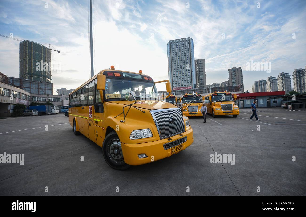 (140523) -- DEQING COUNTY, May 23, 2014 (Xinhua) -- A government-funded school bus leaves its terminal to pick up students in Deqing County, east China s Zhejiang Province, May 23, 2014. Since 2009, Deqing county has budgeted 25 million yuan (four million U.S. dollars) for school bus purchasing, with an additional annual subsidy of six million yuan (0.96 million U.S. dollars). The county s 93 customized school buses are now taken by nearly 7,000 students commuting between home and school. The school buses, run and managed by a government-owned subsidiary, are equipped with GPS and video monito Stock Photo