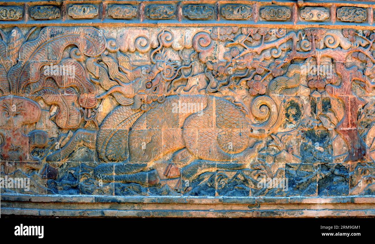 (140523) -- ZHENGZHOU, May 23, 2014 (Xinhua) -- Photo taken on May 23, 2010 shows the brick relief of a Qilin, an auspicious beast in Chinese mythology, at the Anguo Temple in Licun Township of Shanxian County, central China s Henan Province. A large number of architectural sculptures have been preserved in historical sites of Henan, which is one of the cradles of the Chinese civilization. Many of the sculptures, created from stones, bricks, or wood, were used as building parts of residences, shrines and memorial archways, among other architecture types. Underlining both the mood and the detai Stock Photo