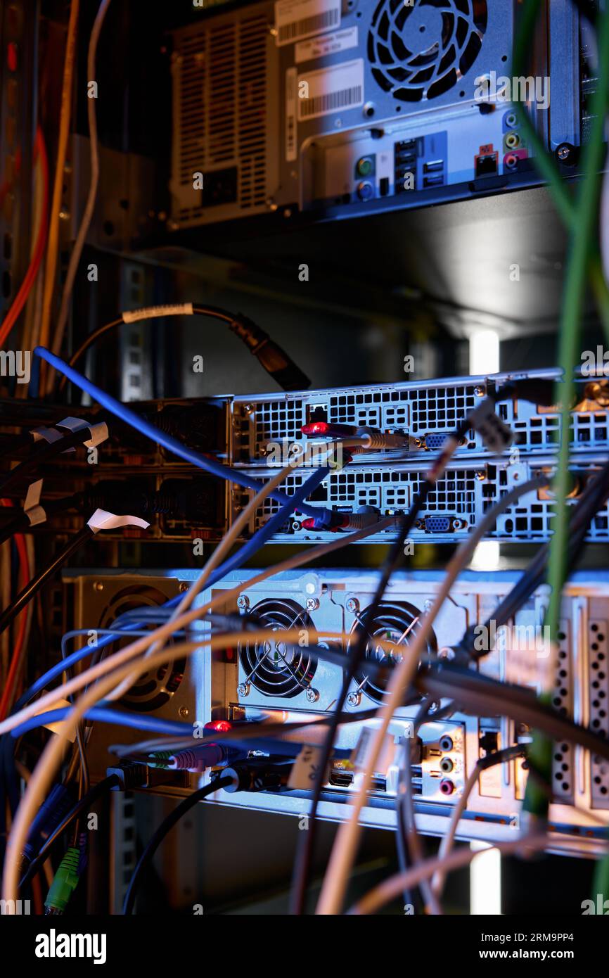 Closeup data wires and cables in dark server room Stock Photo