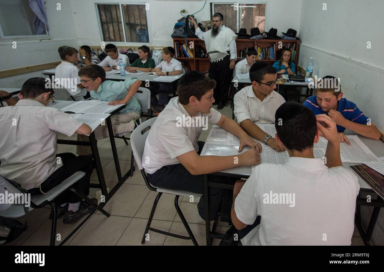 Orthodox Jewish pupils have discussions during a class of Jewish religion at Torat Moshe elementary school in Beit Shemesh, about 20 km from Jerusalem, on May 29, 2014. Tzviel Noyman is an Israeli Ultra-Orthodox boy in a family with six children, three boys and three girls. He is ten years old this year and a grade three pupil of Torat Moshe elementary school, which is only opened to Jewish children. Tzviel has eight classes each day, including Hebrew, English, mathematics and Jewish religion, which has four classes each day including Talmud, Mishnah and Gemara. Tzviel likes the religion class Stock Photo