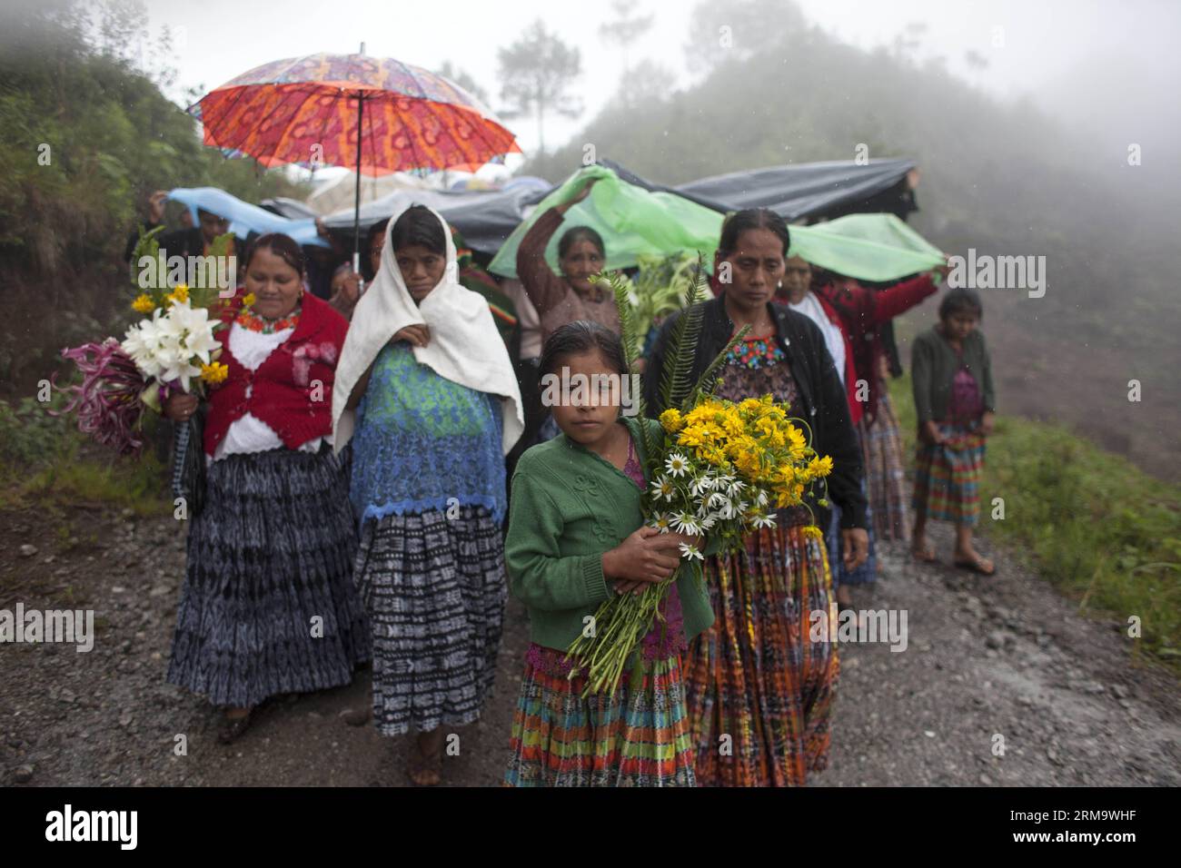(140603) -- SANTA CRUZ VERAPAZ, June 3, 2014 (Xinhua) -- People participate in a funeral of six villagers 32 years after they vanished, at Pambach village, at Santa Cruz Verapaz township, in Alta Verapaz department, Guatemala, on June 2, 2014. On June 2, 1982, Guatemala s Army soldiers arrived at Pambach village, where 82 people vanished. Guatemala s Forensic Anthropology Foundation (FAFG, for its acronym in spanish), identified remains from six of them, found near United Nations Regional Center of Peacekeeping Operations Training, an old military base in Alta Verapaz department, and delivered Stock Photo