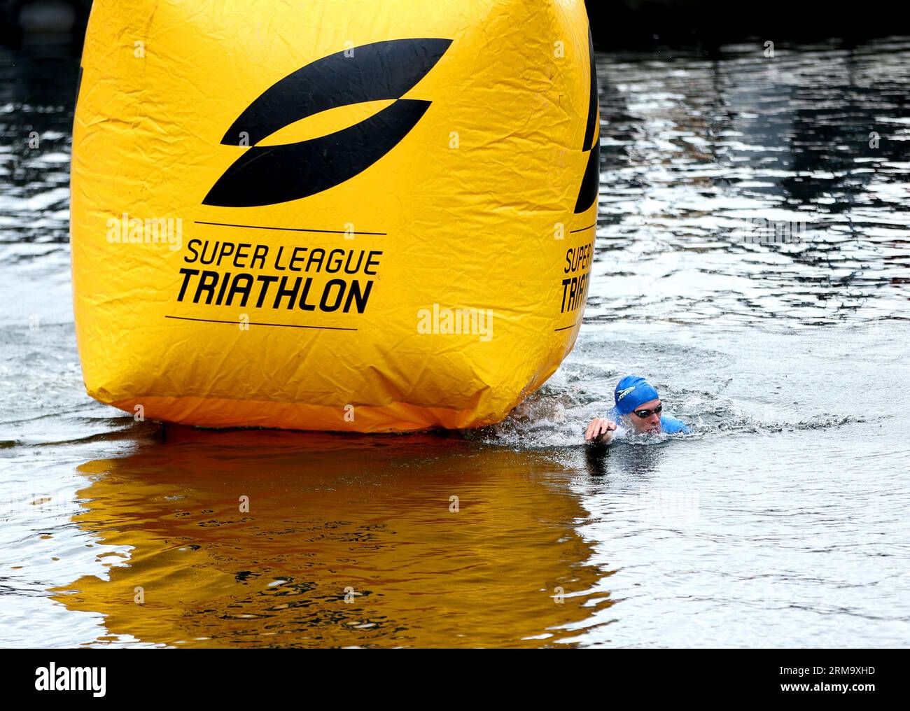 Max Stapley leads in the water at the start of the Men's Race during