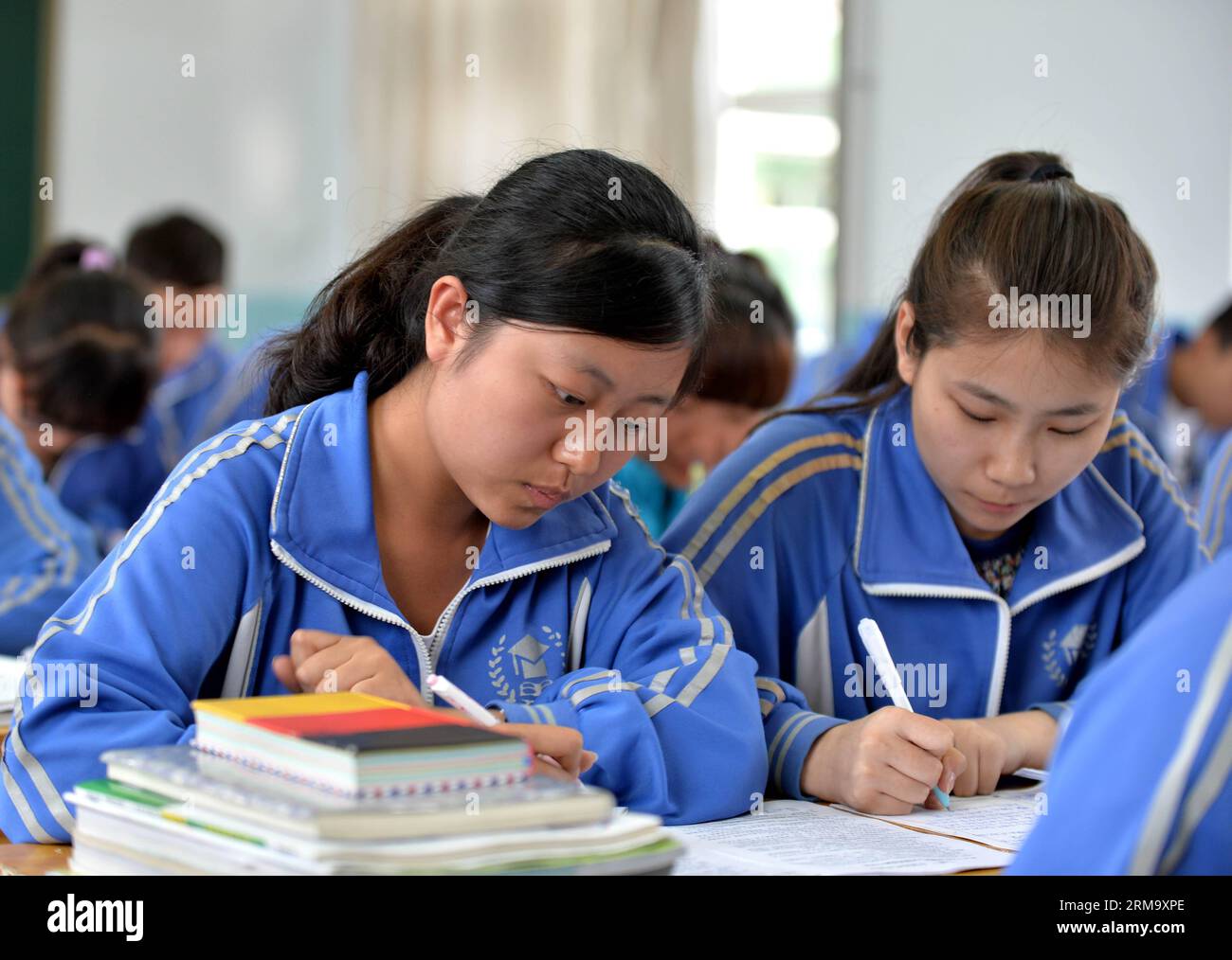 Gaokao candidate Duan Xinran (L) reviews for the coming national college entrance exam at a high school in Hohhot City, north China s Inner Mongolia Autonomous Region, June 4, 2014. As the annual national college entrance exam, known as gaokao approaches, candidates seize the last minute to prepare for the exam. The exam, which will be held this weekend, attracted nearly 9.4 million participants this year. (Xinhua/Ren Junchuan) (lfj) CHINA-INNER MONGOLIA-HOHHOT- GAOKAO -PREPARATION (CN) PUBLICATIONxNOTxINxCHN   gaokao Candidate Duan Xinran l Reviews for The Coming National College Entrance Exa Stock Photo