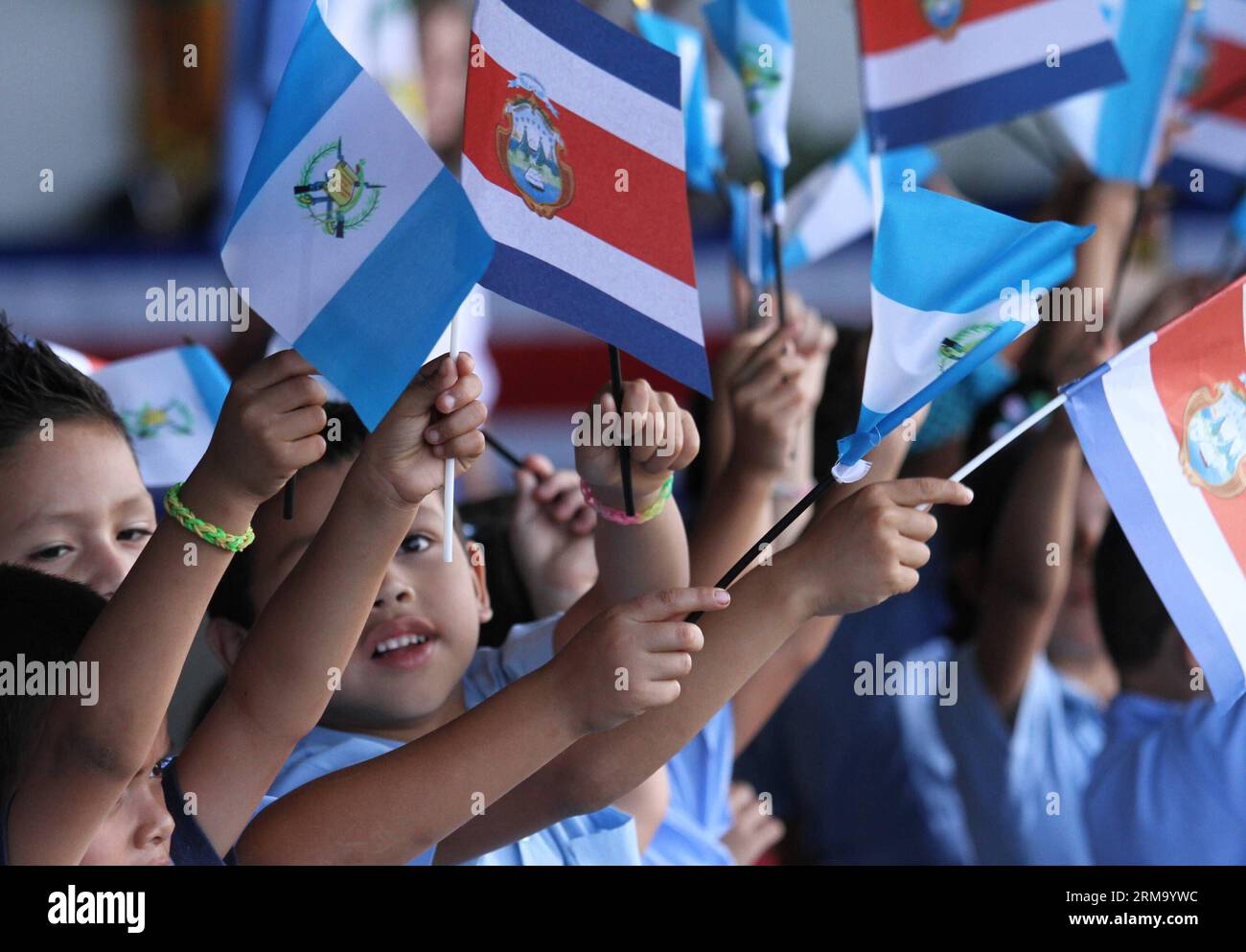 Students wave flags upon the arrival of Guatemalan President Otto Perez Molina, at the Juan Santa Maria International Airport, 20km west of San Jose, capital of Costa Rica, on June 6, 2014. (Xinhua/Kent Gilbert) (bxq) COSTA RICA-SAN JOSE-GUATEMALA-POLITICS-VISIT PUBLICATIONxNOTxINxCHN   Students Wave Flags UPON The Arrival of Guatemalan President Otto Perez Molina AT The Juan Santa Mary International Airport 20Km WEST of San Jose Capital of Costa Rica ON June 6 2014 XINHUA Kent Gilbert  Costa Rica San Jose Guatemala POLITICS Visit PUBLICATIONxNOTxINxCHN Stock Photo