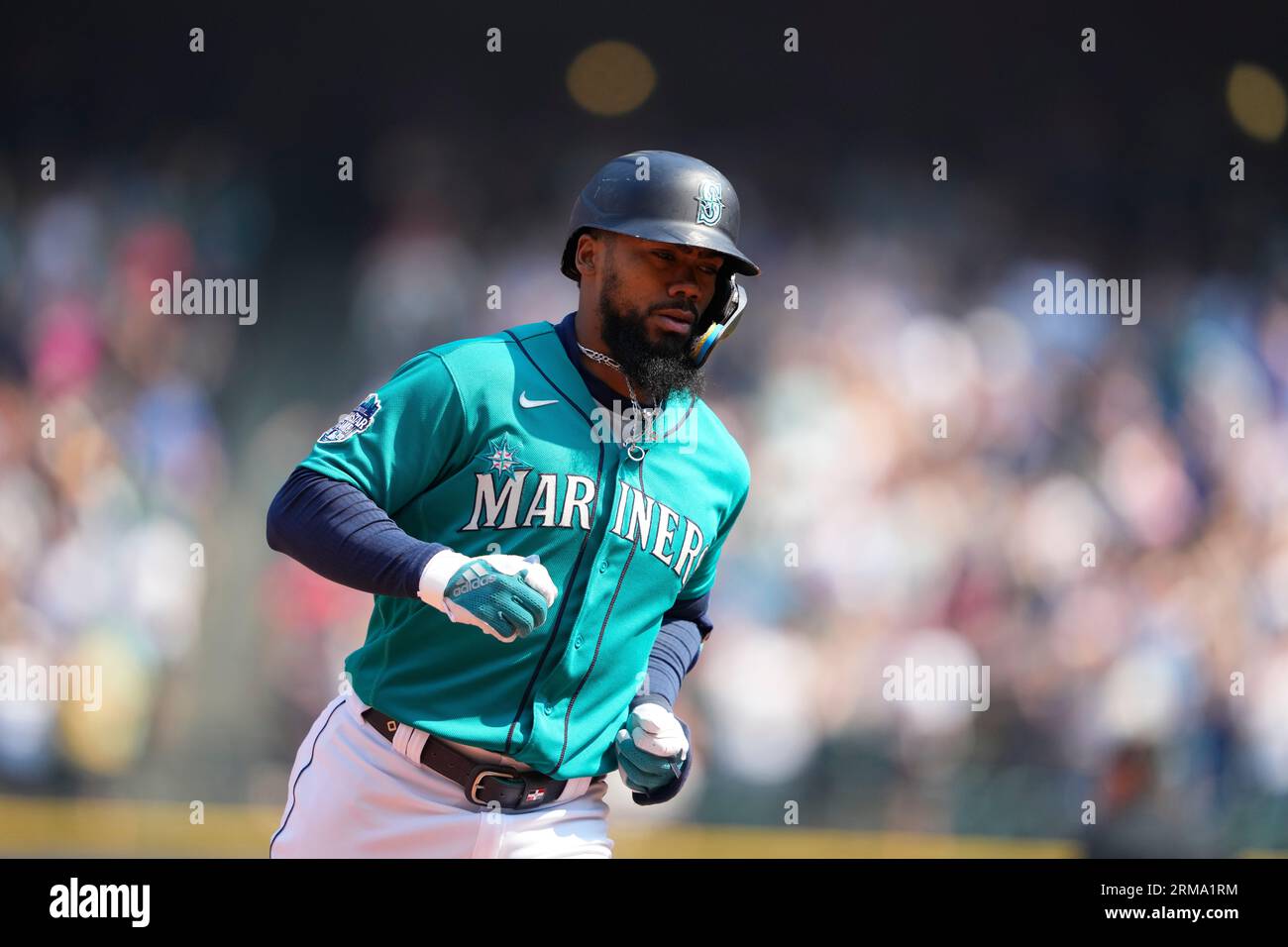 Seattle Mariners' Teoscar Hernandez tries to avoid being doused following a  15-2 win after a baseball game against the Kansas City Royals Saturday,  Aug. 26, 2023 in Seattle. (AP Photo/Lindsey Wasson Stock
