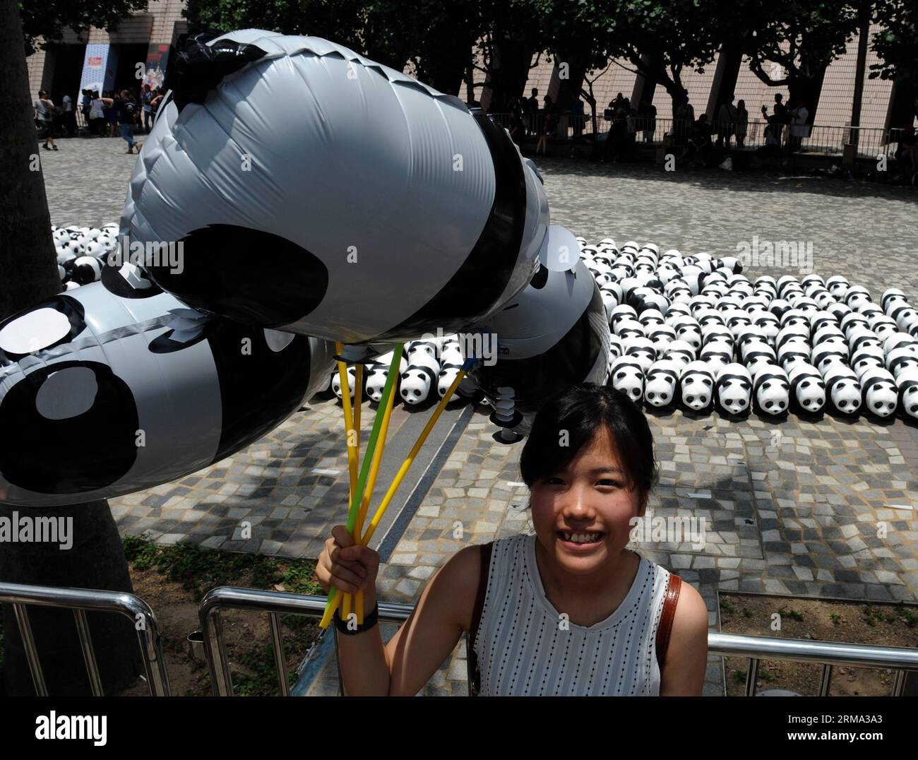 (140614) -- HONG KONG, June 14, 2014 (Xinhua) -- A girl poses for a photo in front of paper pandas during an exhibition in Tsim Sha Tsui, south China s Hong Kong, June 14, 2014. A total of 1,600 paper pandas were displayed here Saturday, which were the work of French artist Paulo Grangeon. (Xinhua/Lo Ping Fai) (hdt) CHINA-HONG KONG-PAPER PANDA (CN) PUBLICATIONxNOTxINxCHN   Hong Kong June 14 2014 XINHUA a Girl Poses for a Photo in Front of Paper Pandas during to Exhibition in Tsim Sha Tsui South China S Hong Kong June 14 2014 a total of 1 600 Paper Pandas Were displayed Here Saturday Which Were Stock Photo