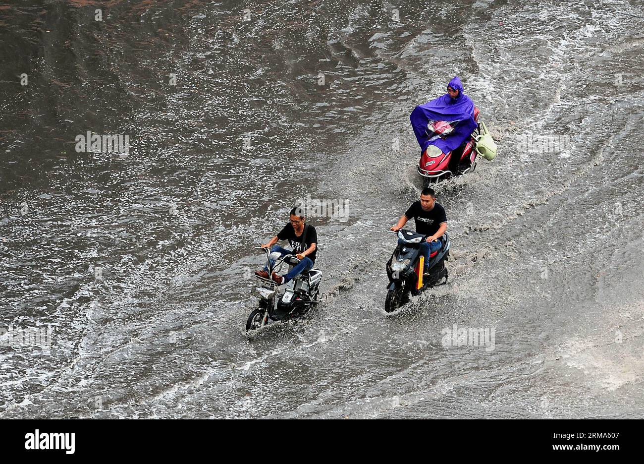 (140619) -- ZHENGZHOU, June 19, 2014 (Xinhua) -- People ride electric vehicles on a flooded road in Zhengzhou, capital of central China s Henan Province, June 19, 2014. The local meteorological authority issued a yellow warning on thunder and heavy rainstorms Thursday. (Xinhua/Wang Song) (mp) CHINA-HENAN-ZHENGZHOU-RAINSTORMS (CN) PUBLICATIONxNOTxINxCHN   Zhengzhou June 19 2014 XINHUA Celebrities Ride Electric VEHICLES ON a flooded Road in Zhengzhou Capital of Central China S Henan Province June 19 2014 The Local Meteorological Authority issued a Yellow Warning ON Thunder and Heavy Rainstorm Th Stock Photo