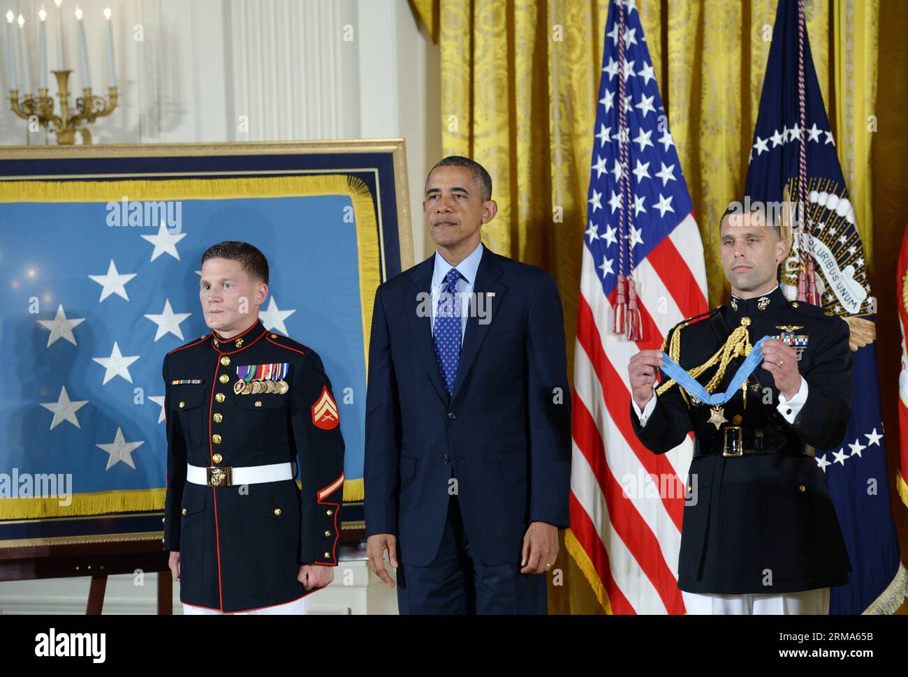(140619) -- WASHINGTON D.C., June 19, 2014 (Xinhua) -- U.S. President Barack Obama (C) stands at a ceremony for awarding William Kyle Carpenter (L) with the Medal of Honor in the East Room of the White House in Washington D.C., the United States, on June 19, 2014. Carpenter received the medal for covering a grenade to save fellow Marines during a Taliban attack in November 2010. Carpenter is the eighth living recipient chosen for the highest military award. (Xinhua/Yin Bogu) US-WASHINGTON D.C.-MEDAL OF HONOR-CARPENTER PUBLICATIONxNOTxINxCHN   Washington D C June 19 2014 XINHUA U S President Ba Stock Photo