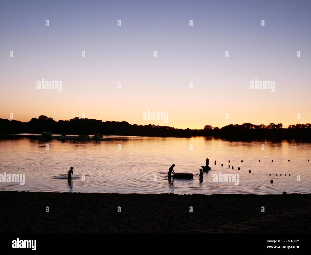 The small lake Saint Aubin at Pouance, France. With an adjacent municipal campsite it is a popular spot for swimming and watersports in the summer. Stock Photo