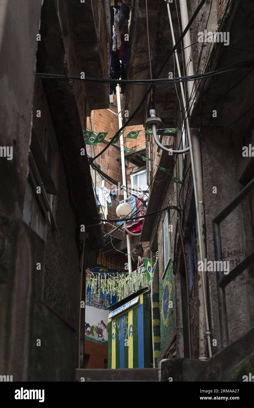 A resident looks out of his window at Favela Santa Marta, Rio de Janeiro, Brazil, on June 26, 2014. Favela Santa Marta, founded in 1920, is one of the oldest favelas in Rio de Janeiro. It became famous in 1996, when American pop singer Michael Jackson recorded a videoclip at Santa Marta for his song They Don t Care About Us. After Pacifying Police Unit (UPP) took control of Santa Marta in 2008, it became a role model for all the favelas in Rio de Janeiro and also a scenic spot. (Xinhua/Guillermo Arias) (SP)BRAZIL-RIO DE JANEIRO-FAVELA SANTA MARTA PUBLICATIONxNOTxINxCHN   a Resident Looks out o Stock Photo