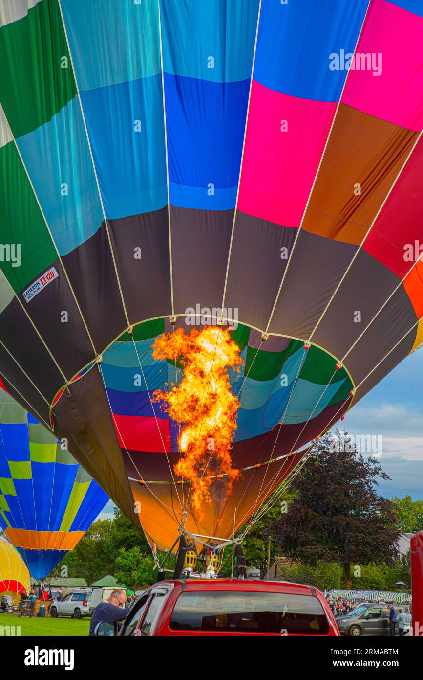 A hot-air balloon being inflated prior to lift-off during Strathaven Balloon Festival 2023 in Strathaven Park, South Lanarkshire, Scotland. Stock Photo
