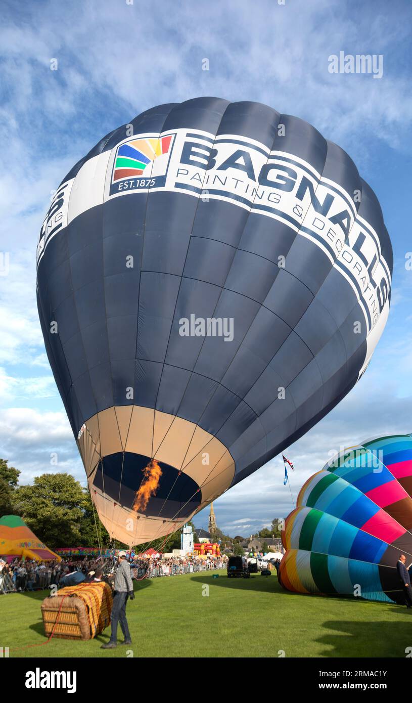Hot-air balloons being inflated prior to lift-off during Strathaven Balloon Festival 2023 in Strathaven Park, South Lanarkshire, Scotland. Stock Photo