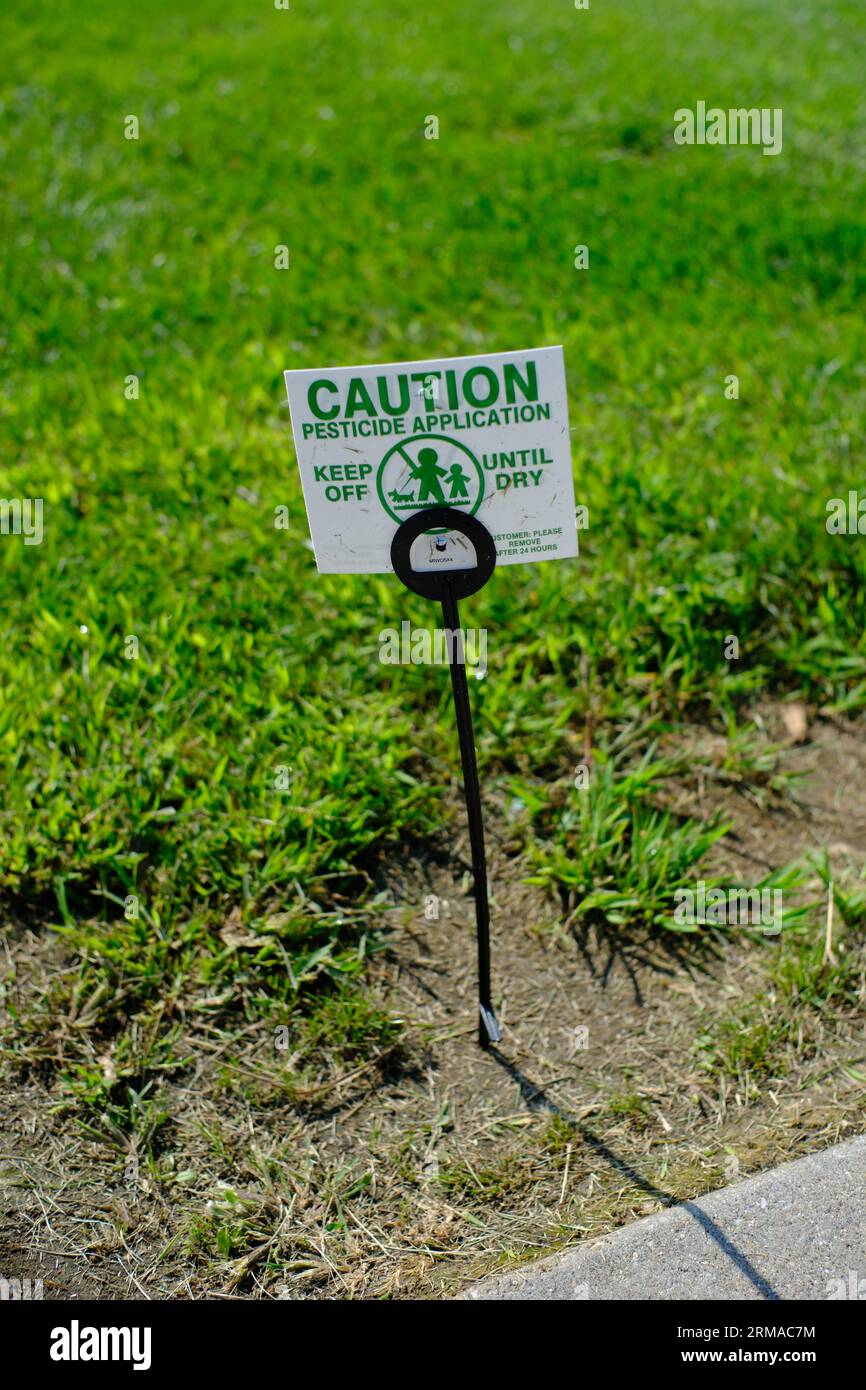 Yard sign warning of pesticide application Stock Photo