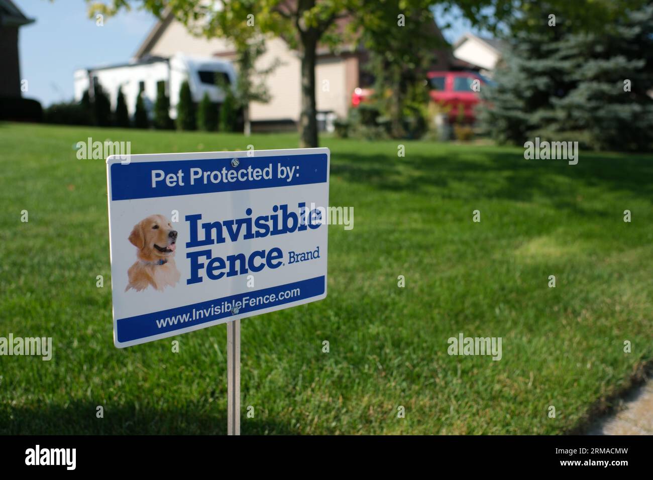 Invisible Fence sign on a suburban yard Stock Photo
