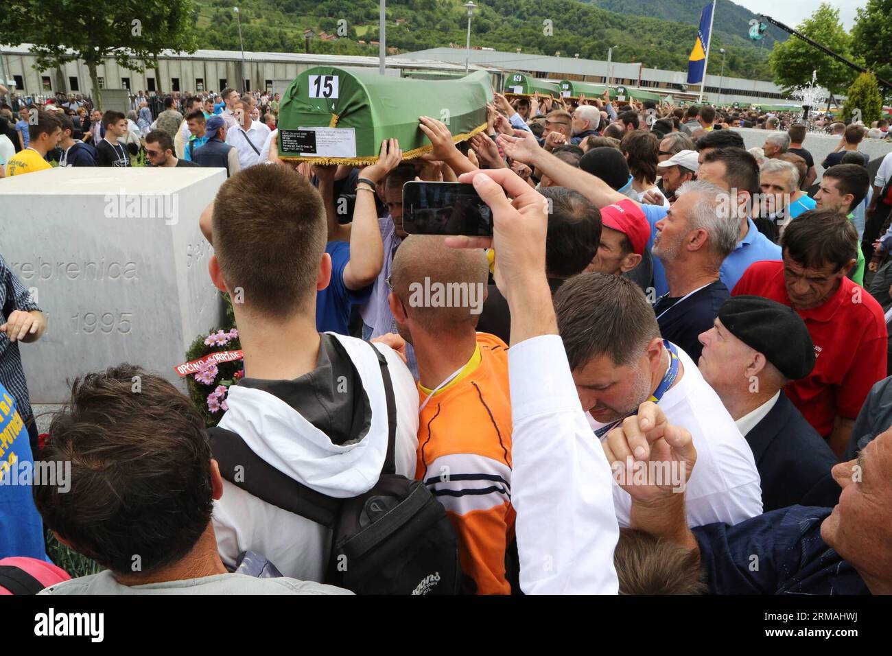 People carry coffins of victims during a funeral in Potocari, near Srebrenica, Bosnia and Herzegovina, July 11, 2014. The funeral of 175 recently identified victims was held here Friday to commemorate the 19th anniversary of the Srebrenica massacre. Some 7,000 Muslim men and boys were massacred in and near Srebrenica by Bosnian Serb forces in July 1995, the worst massacre in Europe since the end of World War II. (Xinhua/Haris Memija) (zjl) BIH-SREBRENICA-MASSACRE-19TH ANIVERSARY PUBLICATIONxNOTxINxCHN   Celebrities Carry Coffin of Victims during a Funeral in  Near Srebrenica Bosnia and Herzego Stock Photo