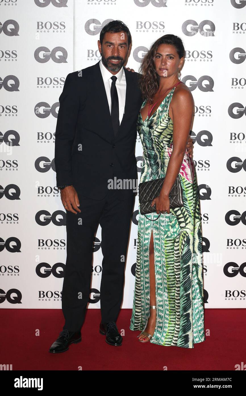 Robert Pires and Jessica Lemarie attend the GQ Men of the Year Awards at Tate Modern  in London. Stock Photo