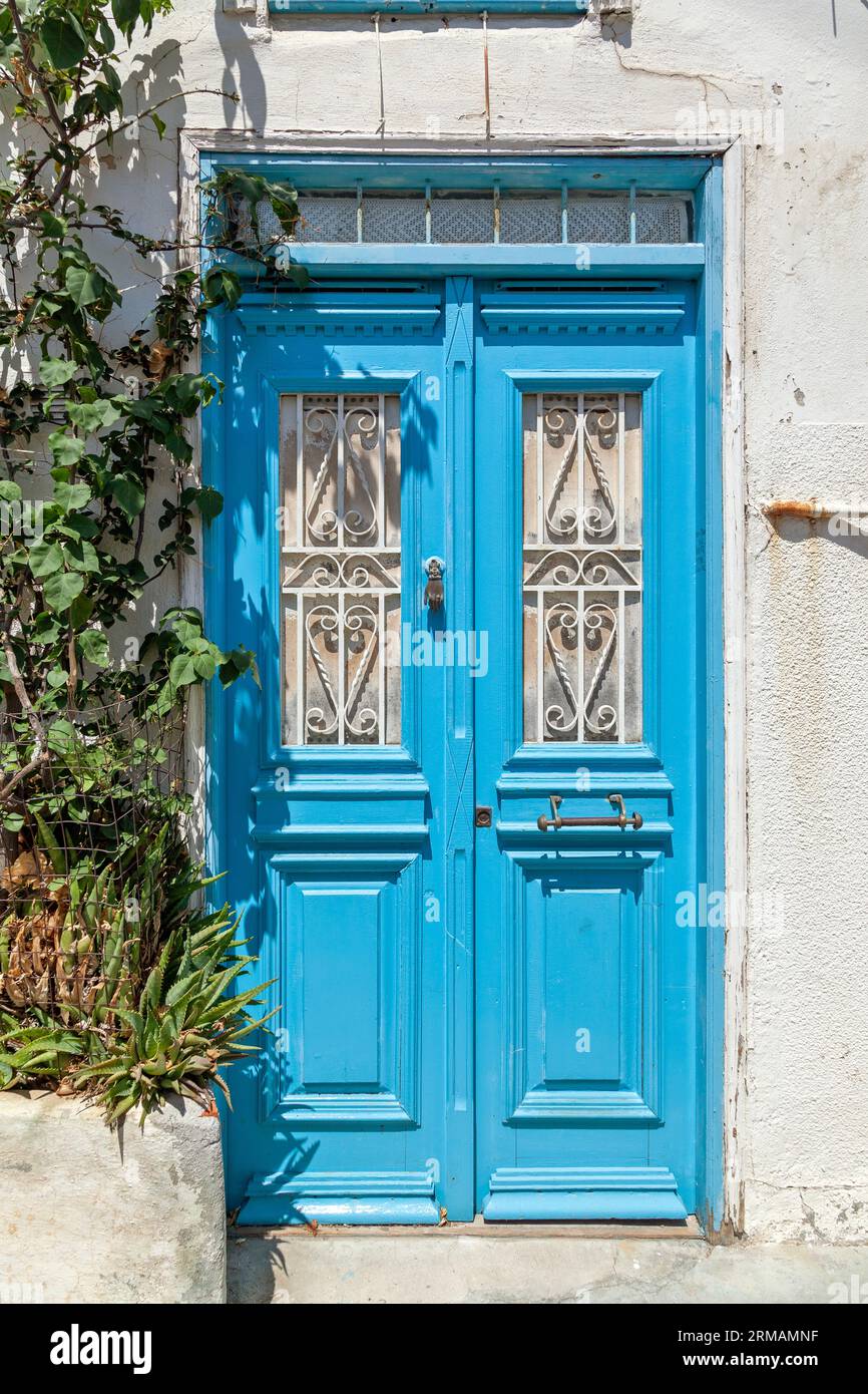 Traditional wooden light-blue door at the picturesque village of Plomari in Lesvos island, northern Aegean Sea, Greece, Europe. Stock Photo