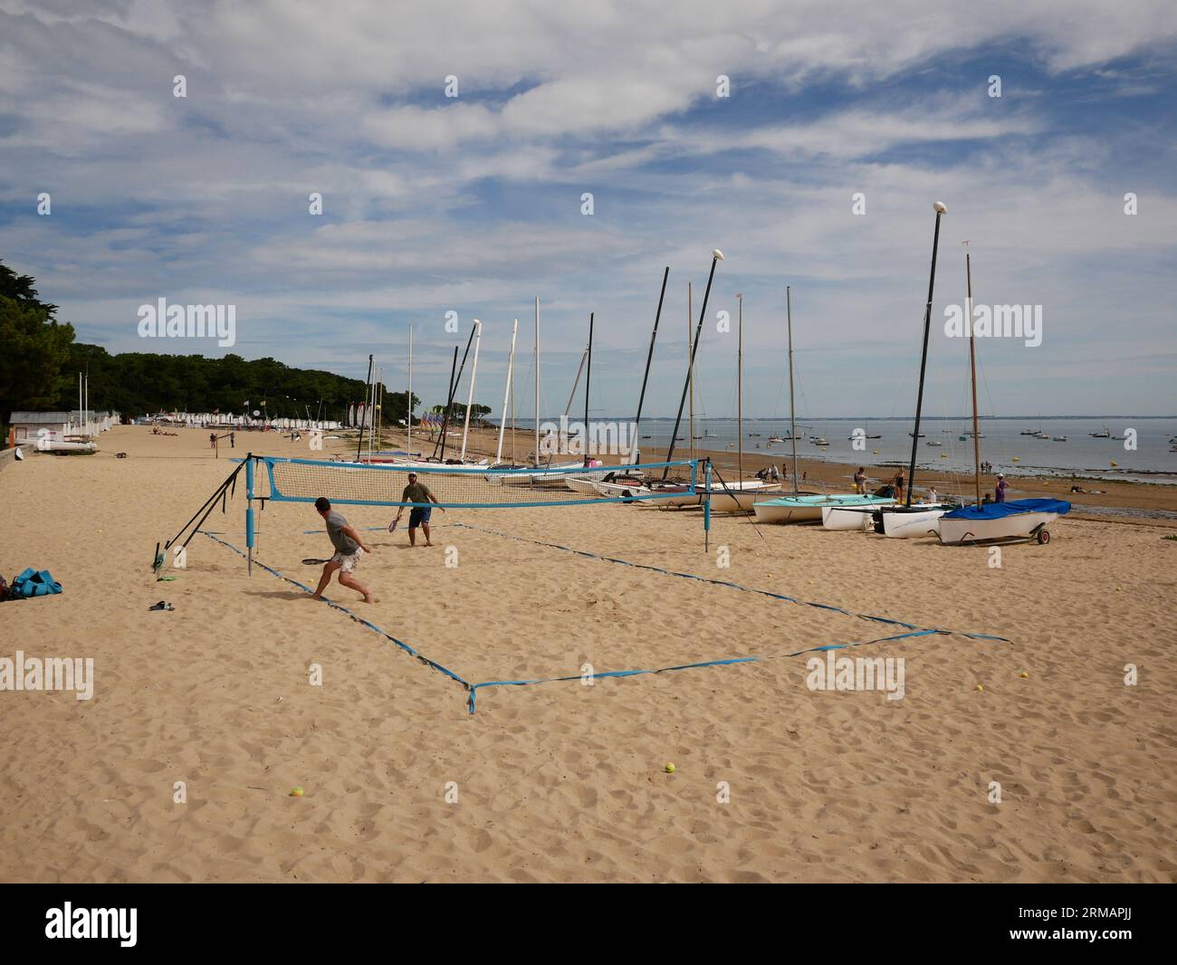 Two men play beach volleyball, Plage de l'Anse Rouge, Ile De Noirmoutier, Vendee, France Stock Photo
