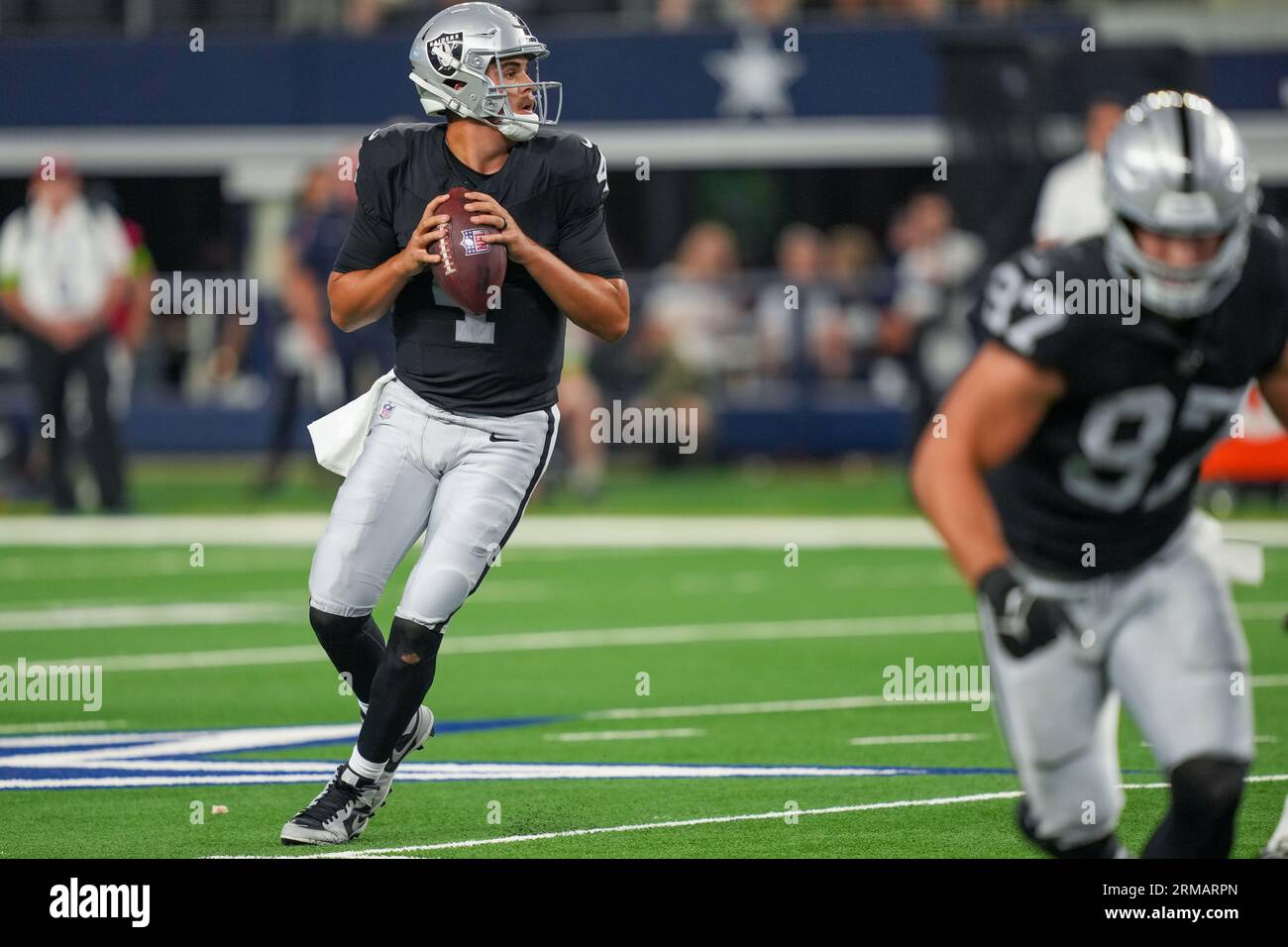 Las Vegas Raiders quarterback Aidan O'Connell (4) gestures as he warms up  before the first half of a preseason NFL football game against the Dallas  Cowboys in Arlington, Texas, Saturday, Aug. 26