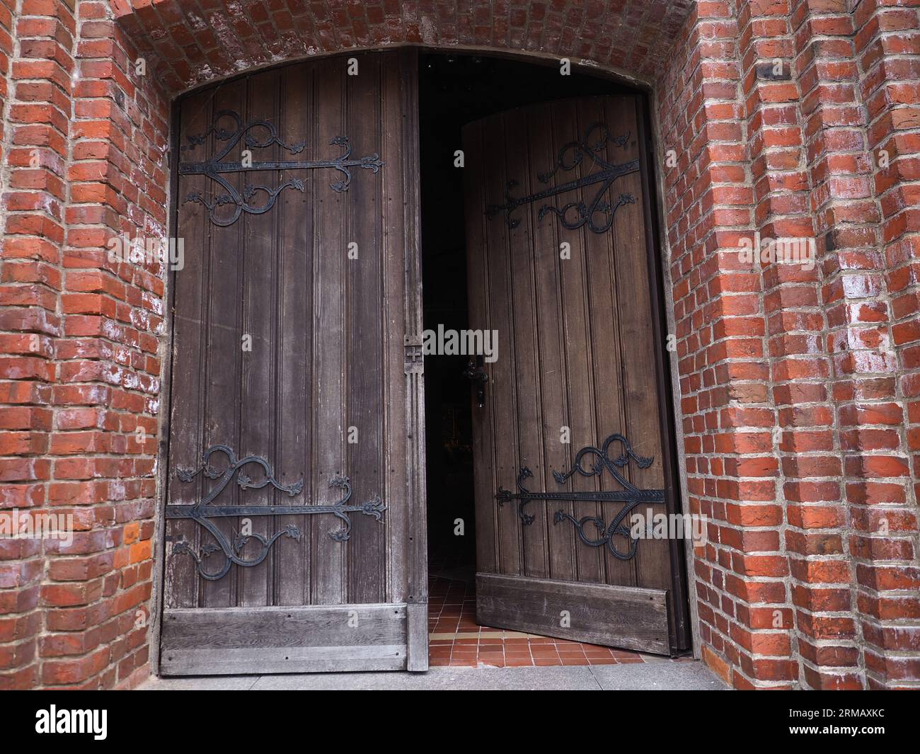 Entrance door of an old church build with bricks Stock Photo