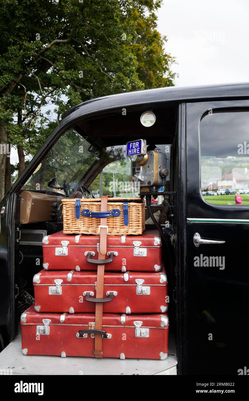 Suitcases and picnic basket on a vintage Beardmore black taxi cab, Helensburgh, Scotland Stock Photo