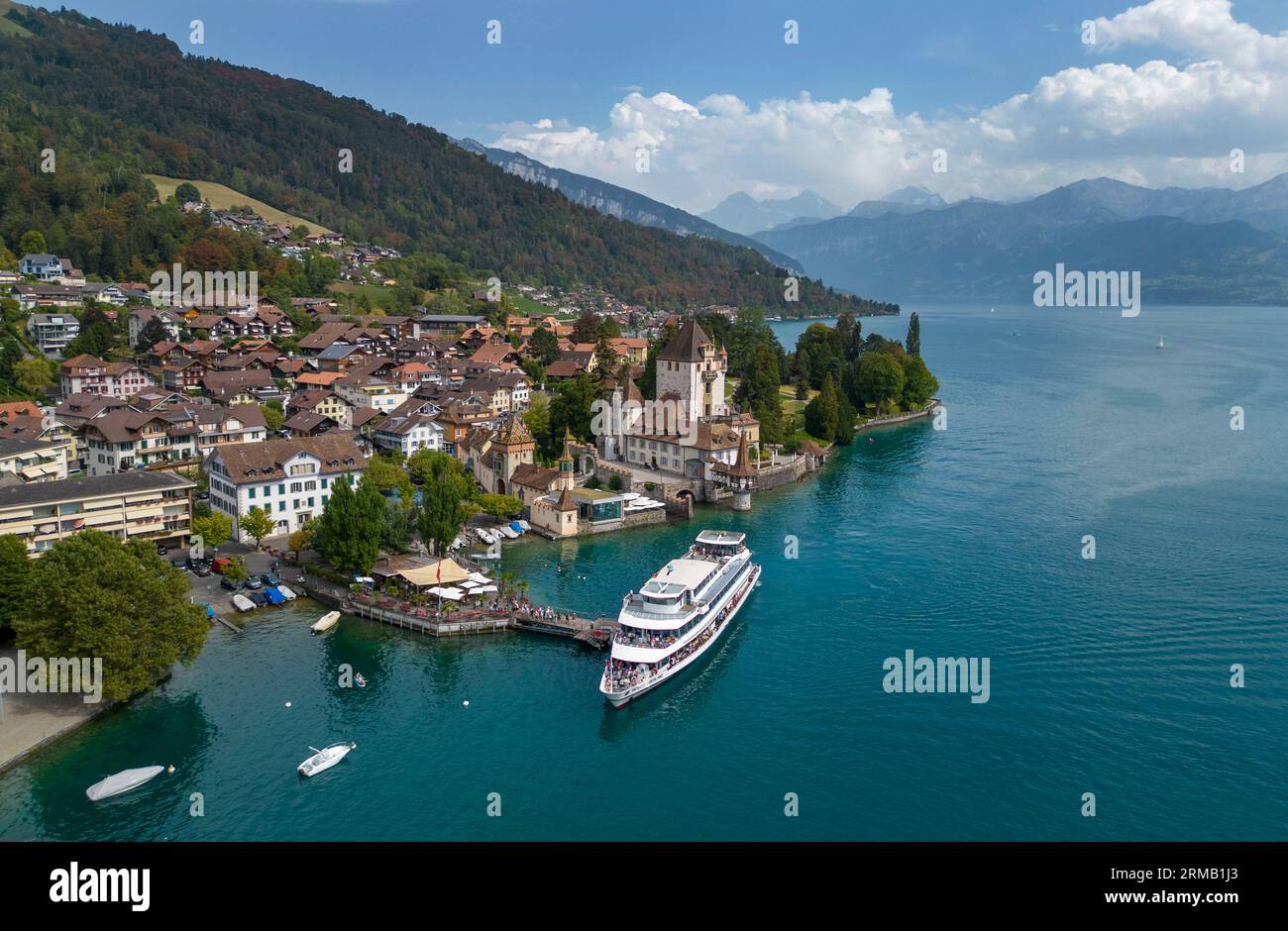 Aerial view of Berner Oberland cruise ship docking at Oberhofen Castle on the shore of Lake Thun, Canton of Bern, Switzerland. Stock Photo