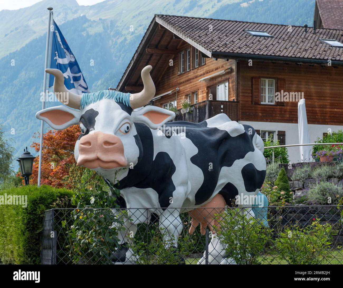 Large sculpture of a dairy cow outside a hotel in Brienz, Canton of Bern, Switzerland. Stock Photo