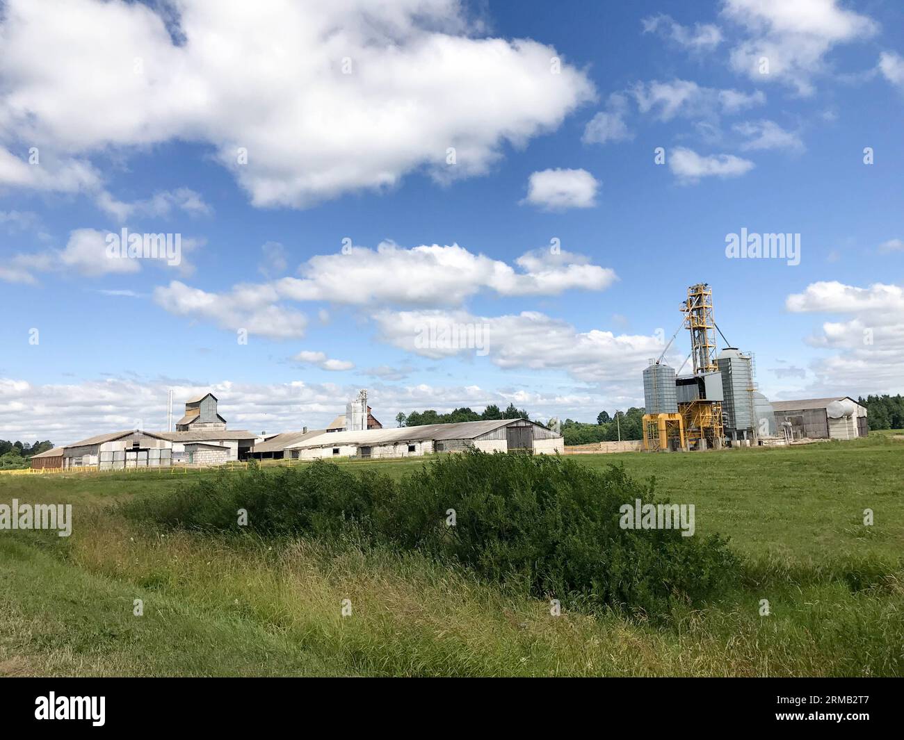 Large agricultural agricultural farm building with equipment, houses, barns, granary. Stock Photo