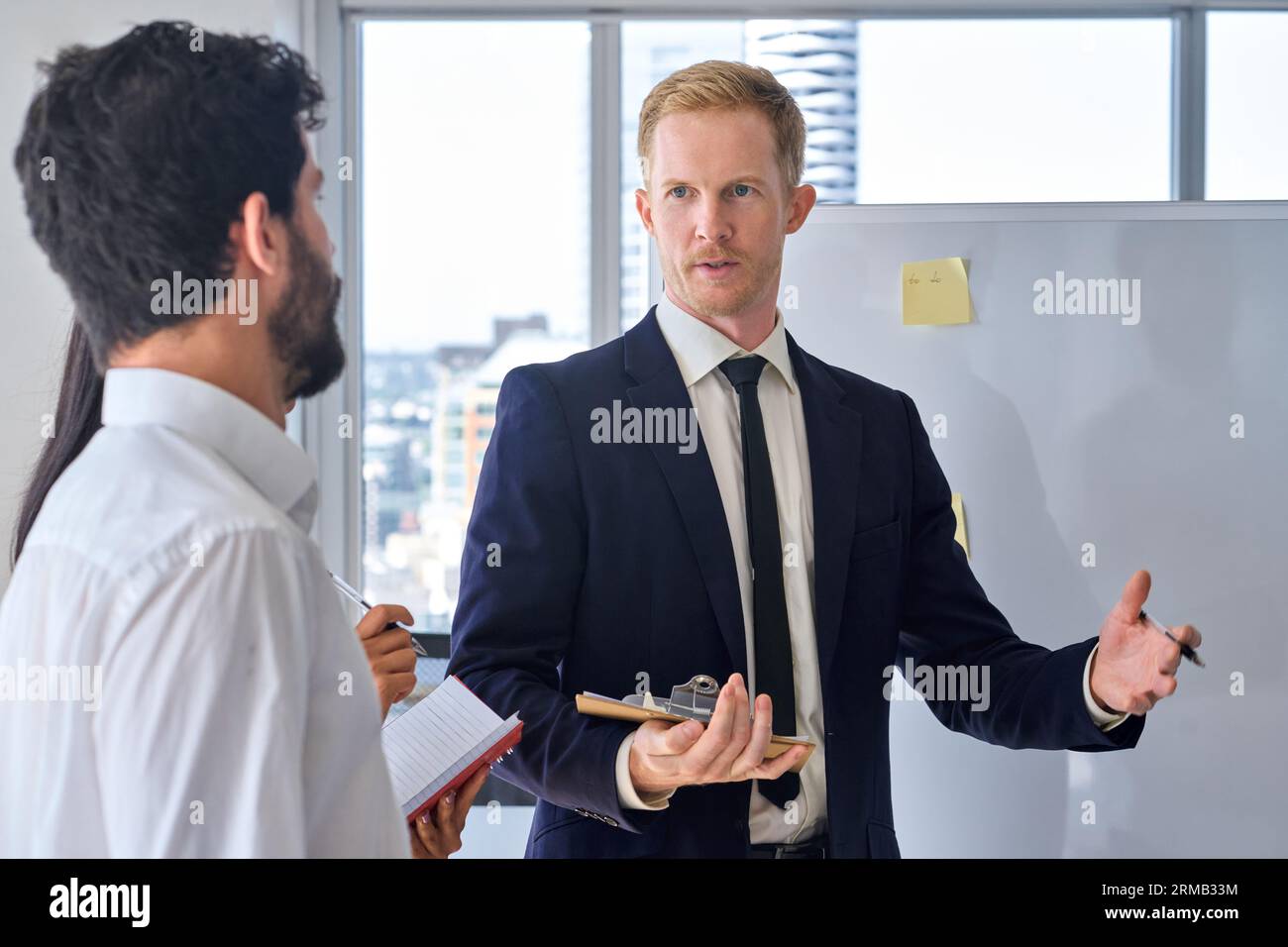 Business man presenter team leader giving presentation in office. Stock Photo