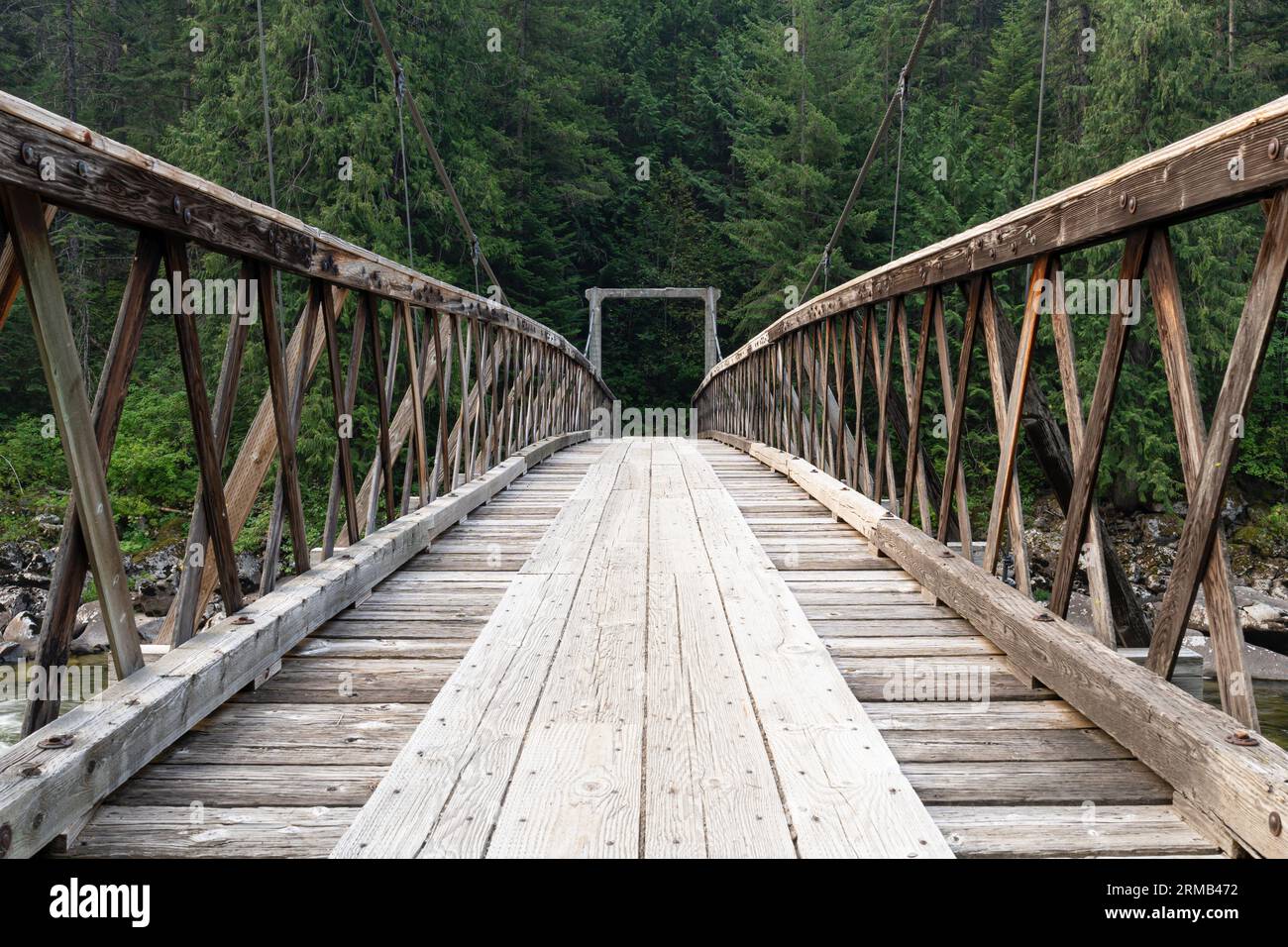 A foot bridge over the Lochsa River in the Clearwater National Forest in central Idaho. Stock Photo