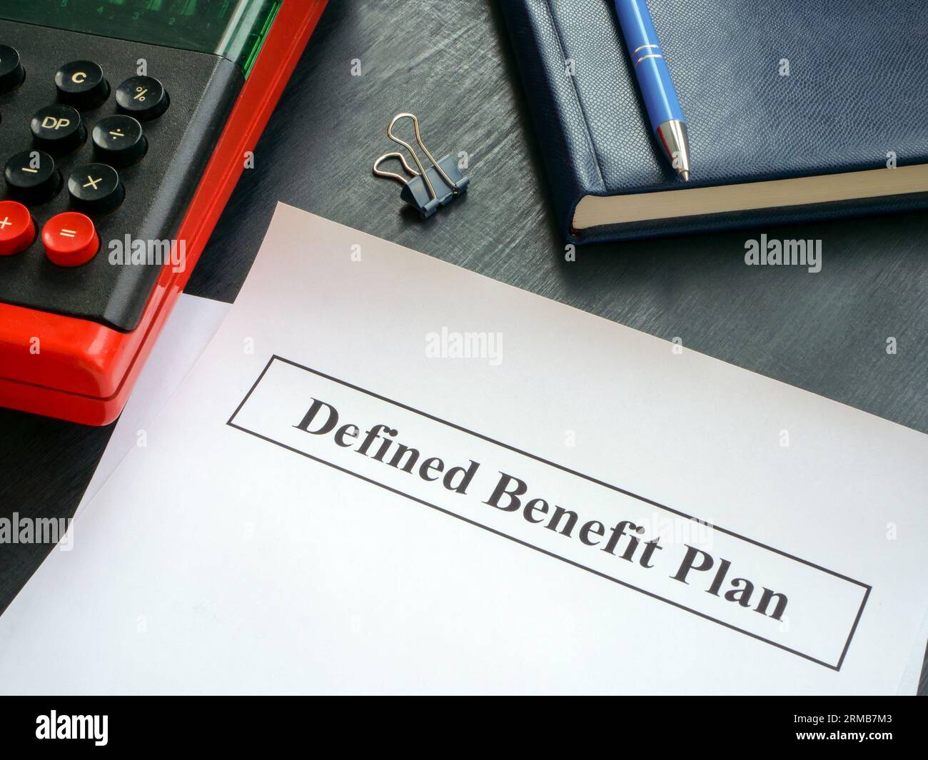 Papers with defined benefit plan and calculator Stock Photo Alamy