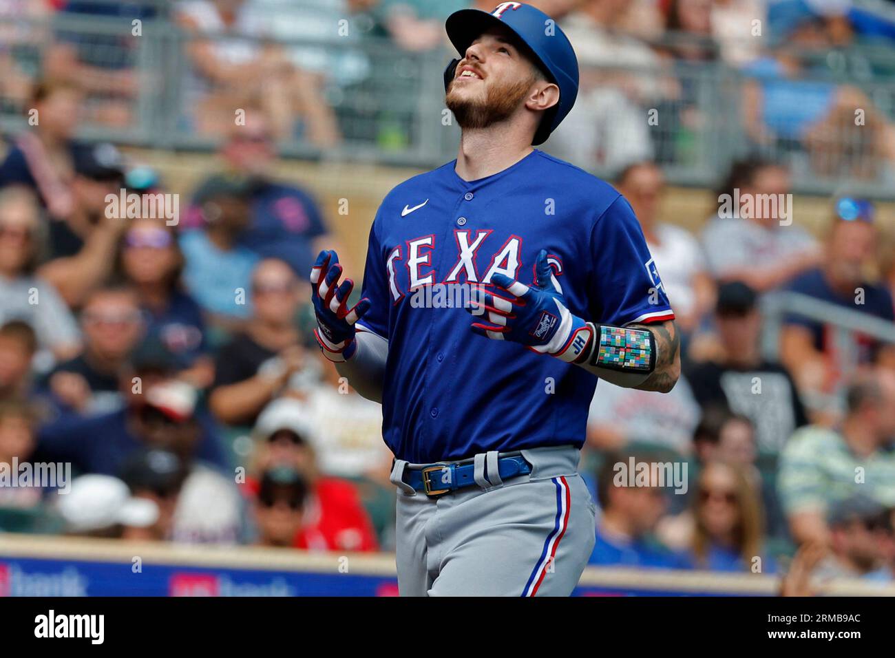 Texas Rangers' Jonah Heim looks to the sky as he scores on his