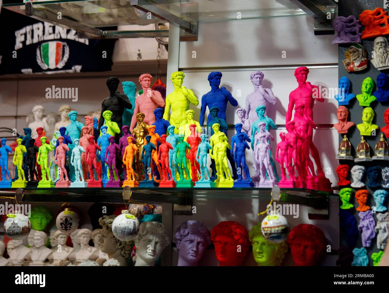 Tourist gifts for sale in Florence including multi coloured statues of Michelangelo's David, Florence, Italy August 2023, Stock Photo