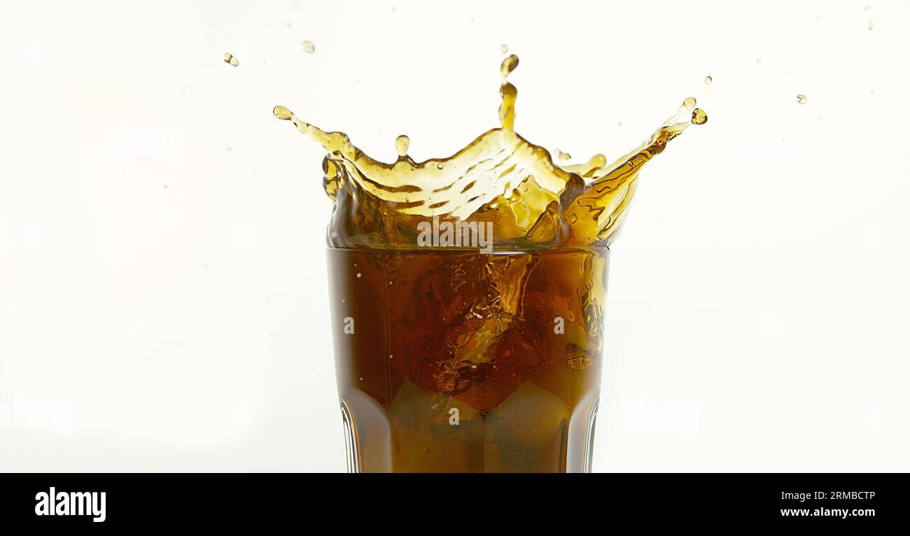 Ice Cubes Falling into Glass of Coke against White Background Stock ...