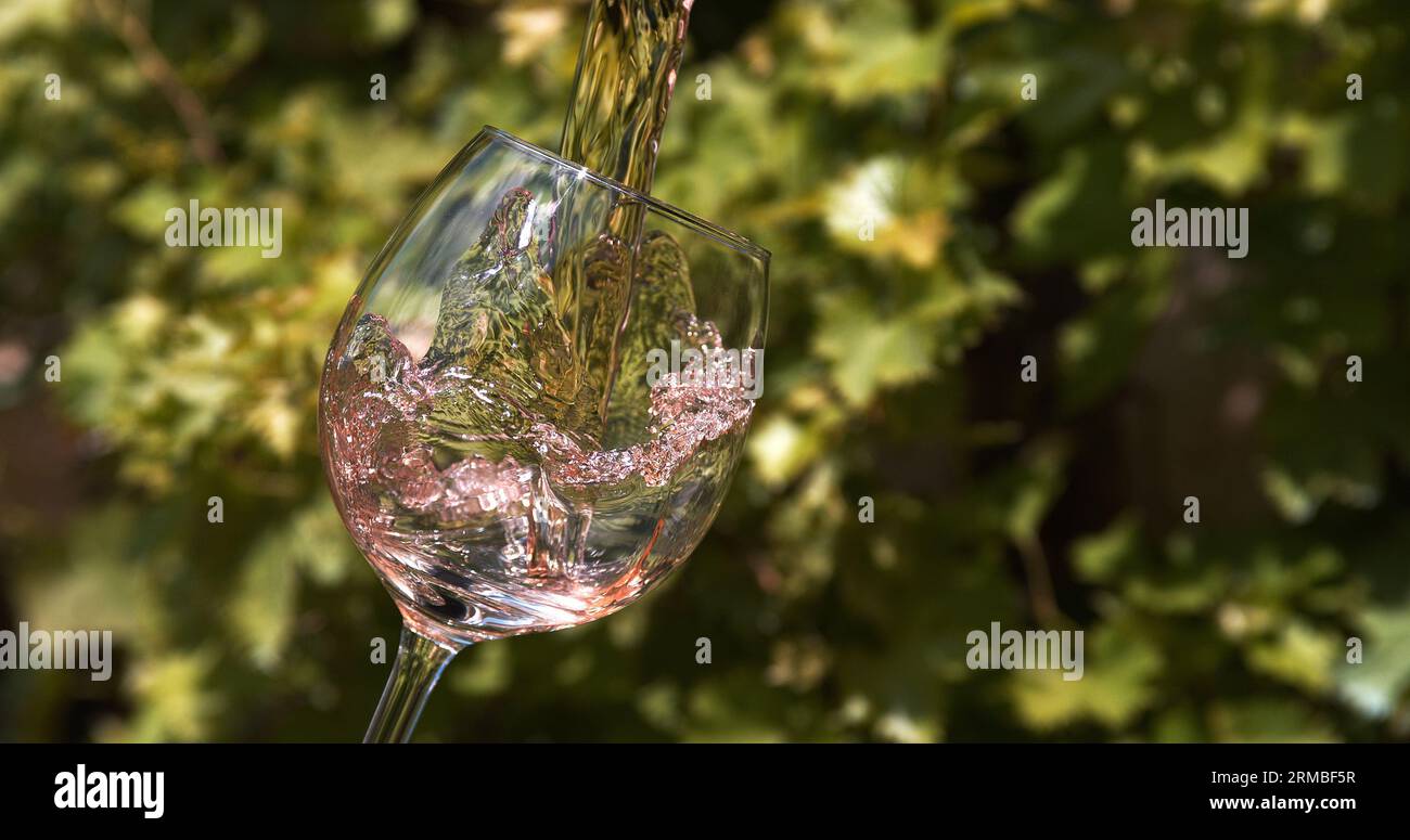 Pink Wine being poured into Glass Stock Photo