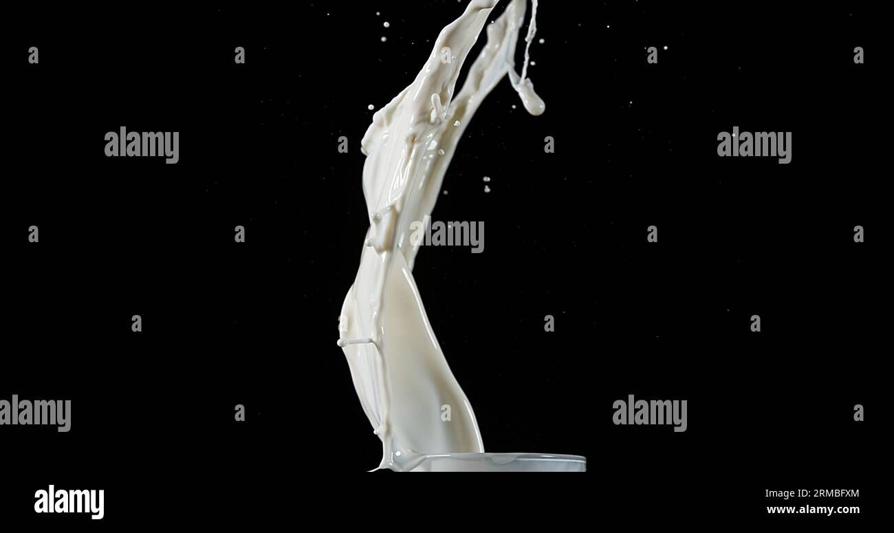 Exploding Milk against Black Background Stock Photo - Alamy