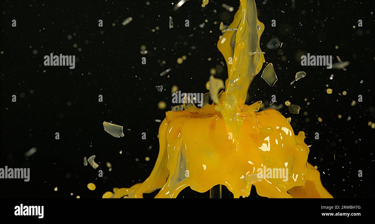 Glass of Orange Exploding against Black Background Stock Photo - Alamy