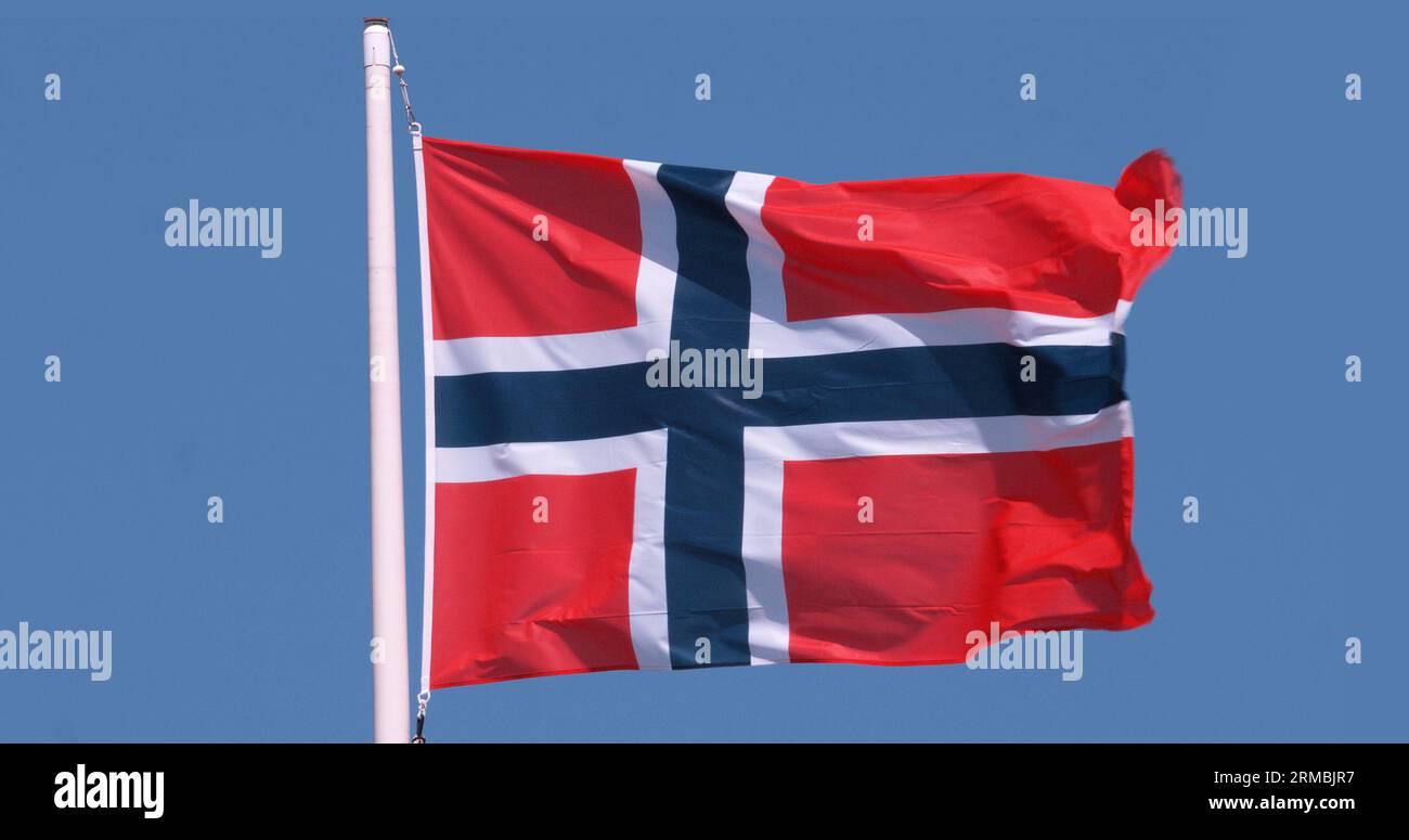 Norwegian Flag Waving in the Wind against blue sky Stock Photo - Alamy