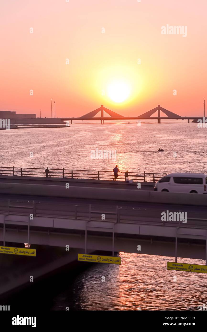 Sunset over the bridge in Bahrain seen from Muharraq district Stock Photo