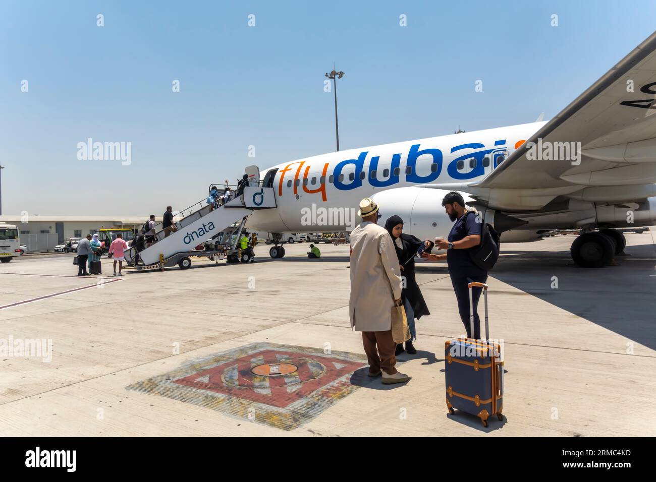Passengers boarding airstairs to FlyDubai aircraft in Dubai Airport
