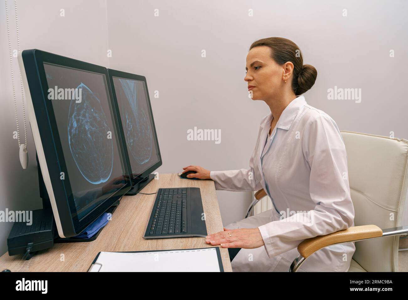 Focused professional doctor radiologist analyzing scan MRI images in ...