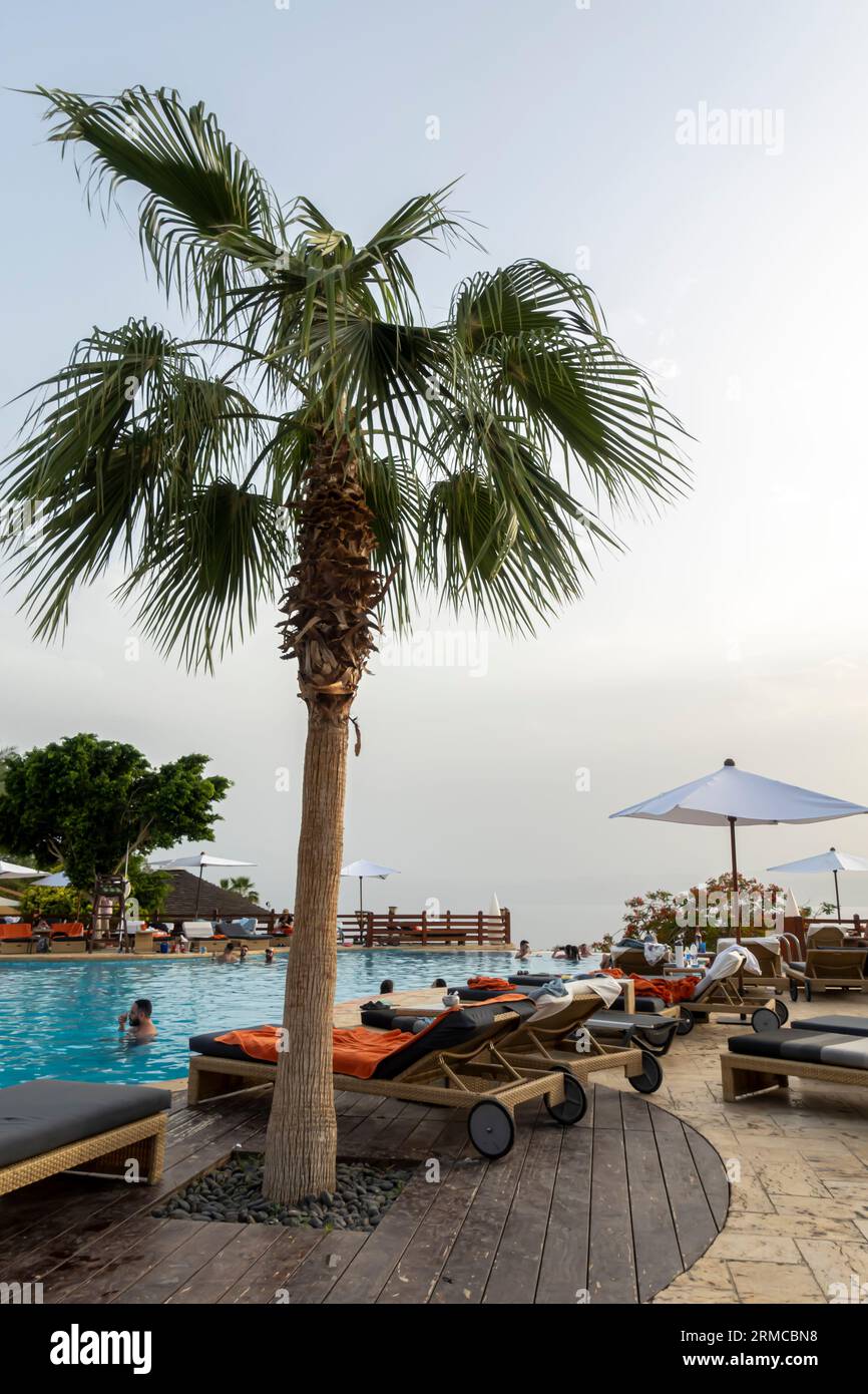 Jordan resort tourism. View of Dead Sea in Jordan. Swimming pool at Dead Sea overlooking the seaside. Stock Photo