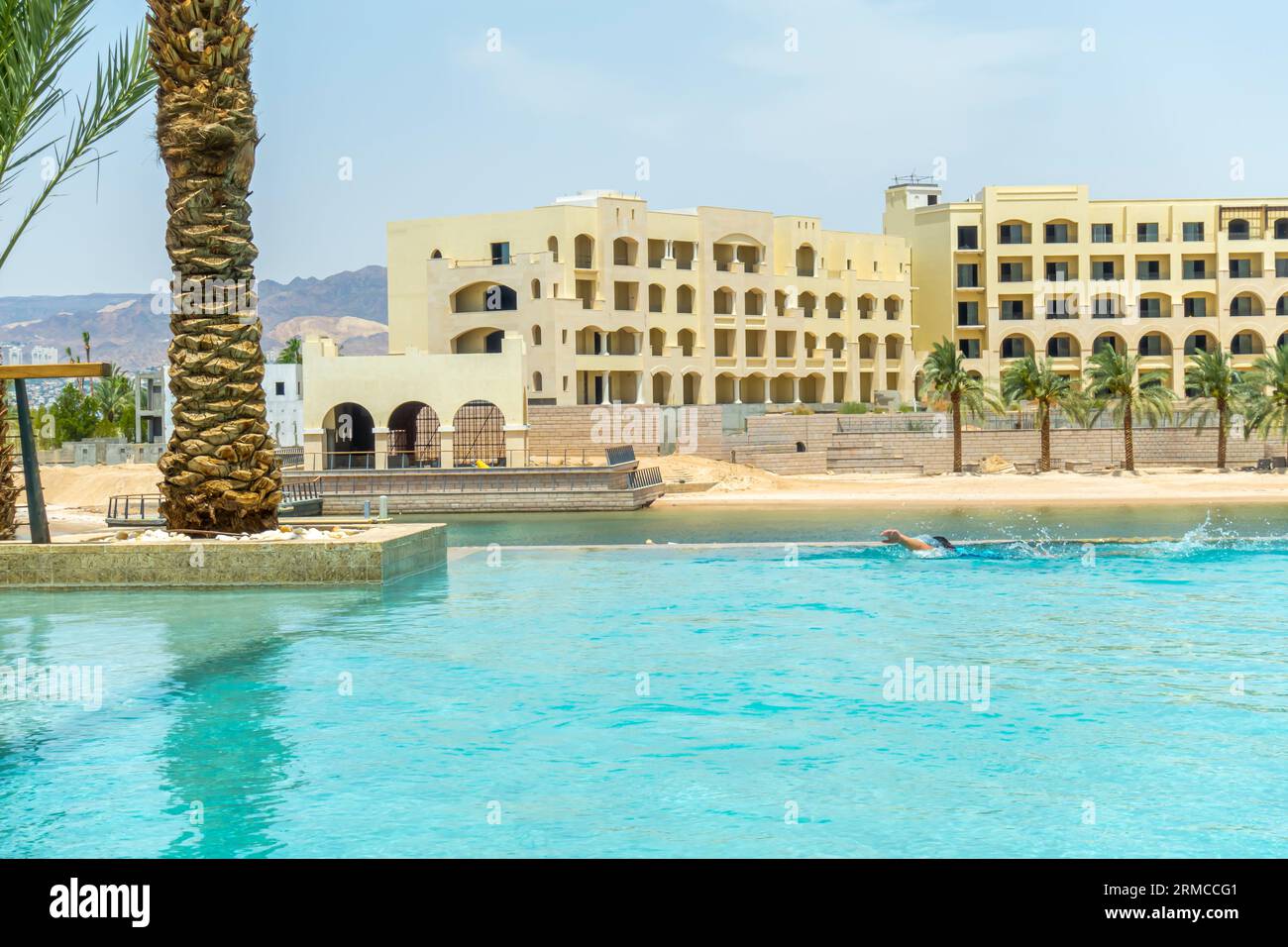 Tourists swim in the pool in the resort lagoon pool in Jordan Middle