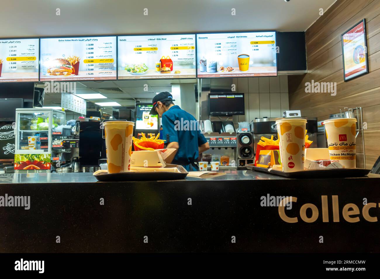 Male employee preparing McDonalds order in McDonalds Aqaba restaurant Jordan Stock Photo