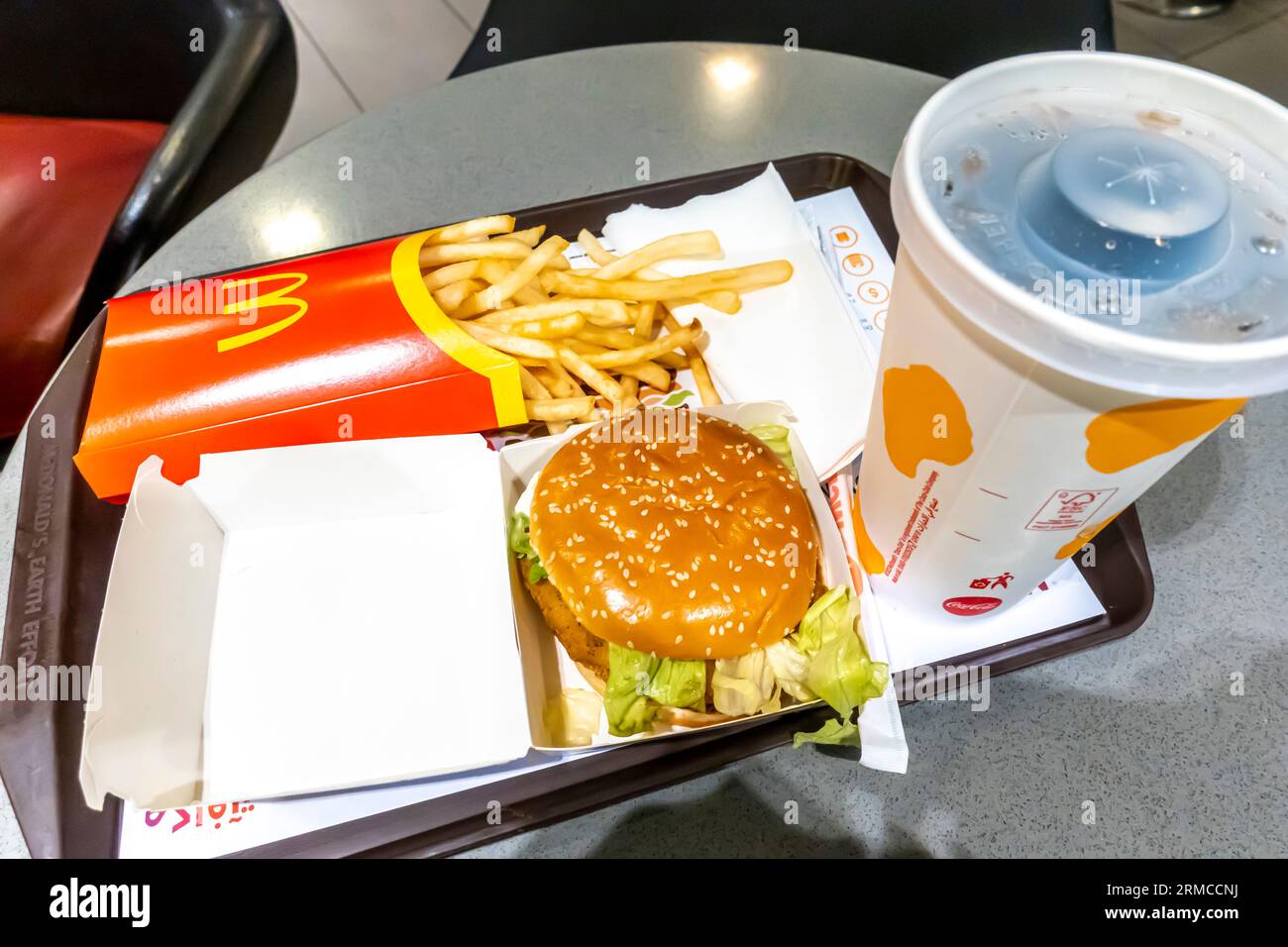 Burger, fries, and cola on the tray in McDonald's restaurant Aqaba