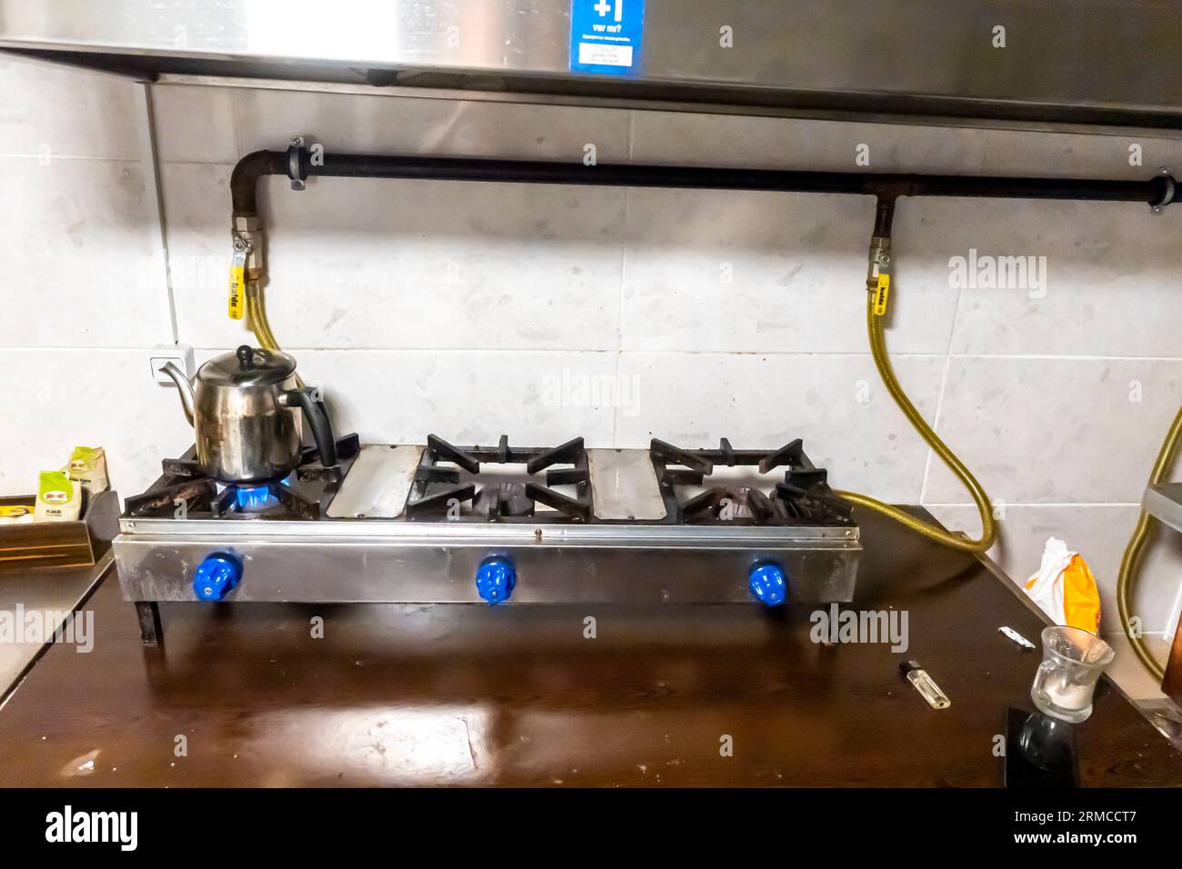 A three burner gas stove, gas handles, gas pipes. home kitchen gas