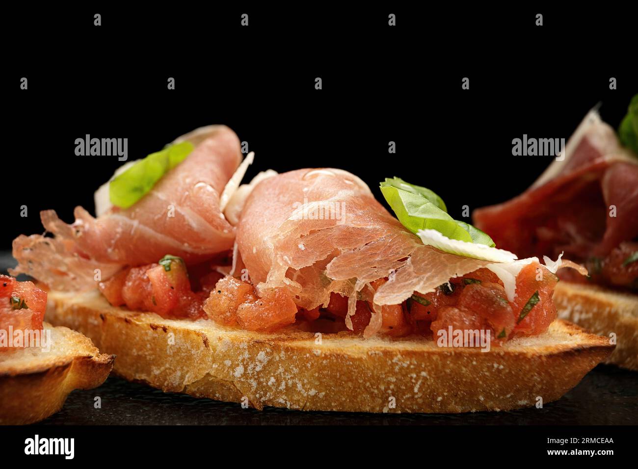 Mouthwatering Bruschetta Topped with Smoked Salmon, Ham and Parmesan