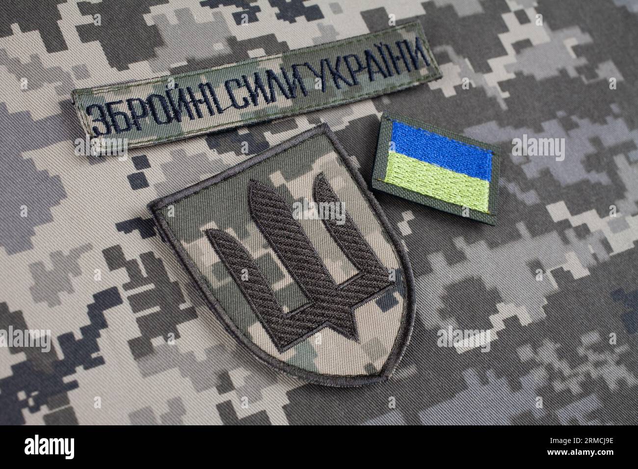 KYIV, UKRAINE - October 6, 2022. Russian invasion in Ukraine 2022. Ukraine Army uniform insignia badges on camouflaged uniform background. Text in ukr Stock Photo
