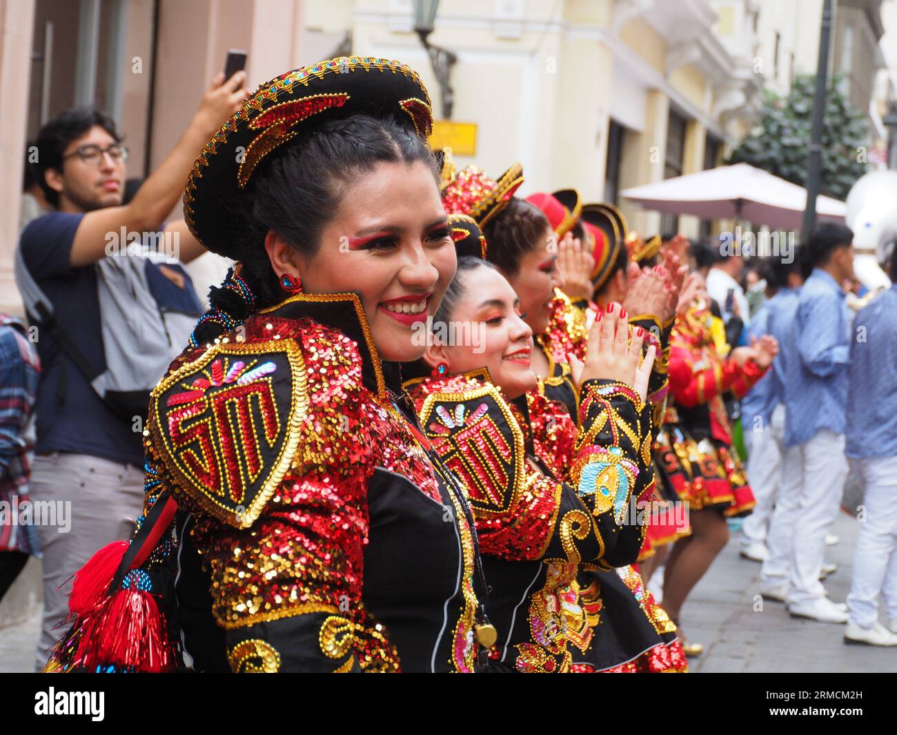 Troupe of women performing a dance and wearing traditional costumes from Virgen of Candelaria Festival, took to the streets of Lima downtown to carry out a Folklore parade. It has become a tradition in Lima for Andean migrants living in Lima use to carry out folk parades to keep alive their traditions. Stock Photo